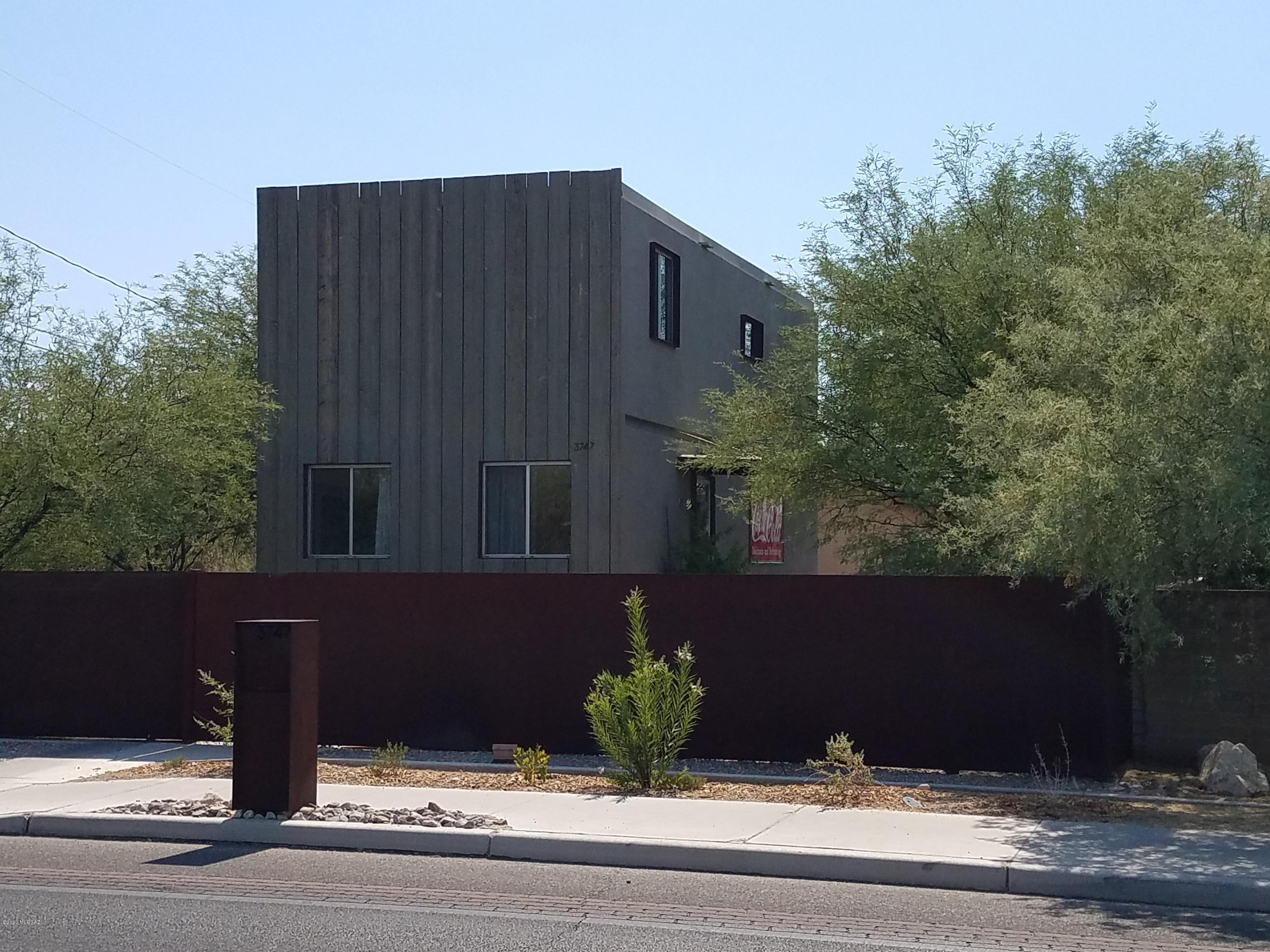 This is The Mountain Avenue container home with high end finishes in kitchen and baths.  The exterior has been clad with wood in the front and stucco on the rest of the sides.  The doorway and windows punctuate the home with fabulous deep steel frames.
The enclosed yard is gated with an automatic gate.  Open floor plan is light and bright and extremely functional.  Located on the bike path, close to The Loop, U of A, Banner, Tucson Racquet Club, UA Farms, shopping.