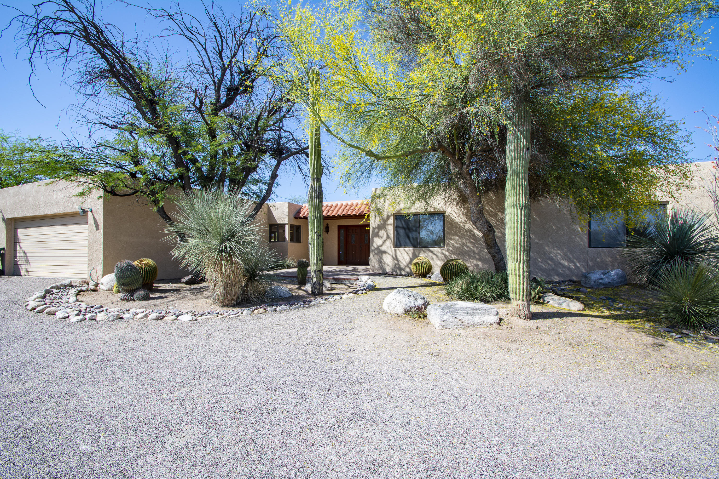 Enchanting custom foothills home tucked away  & private with awe-inspiring views of the Catalinas.  Spacious home with large rooms. Enjoy the covered back patio & inviting pool for another perfect place to catch the mountain views. Master bdrm has own sitting room. Ample guest qtrs also has own sitting room, large bdrm, bath & separate entrance. Kitchen looks over great room w fireplace & big picture windows to capture the extraordinary scenery. Tons of storage. Large garage with a storage rm or make it a workshop. Low care desert landscape. Many custom touches. Just minutes to dining, shopping, parks, dog parks & easy access  to the wonderful Rillito River pathway Loop.  Don't miss this!
