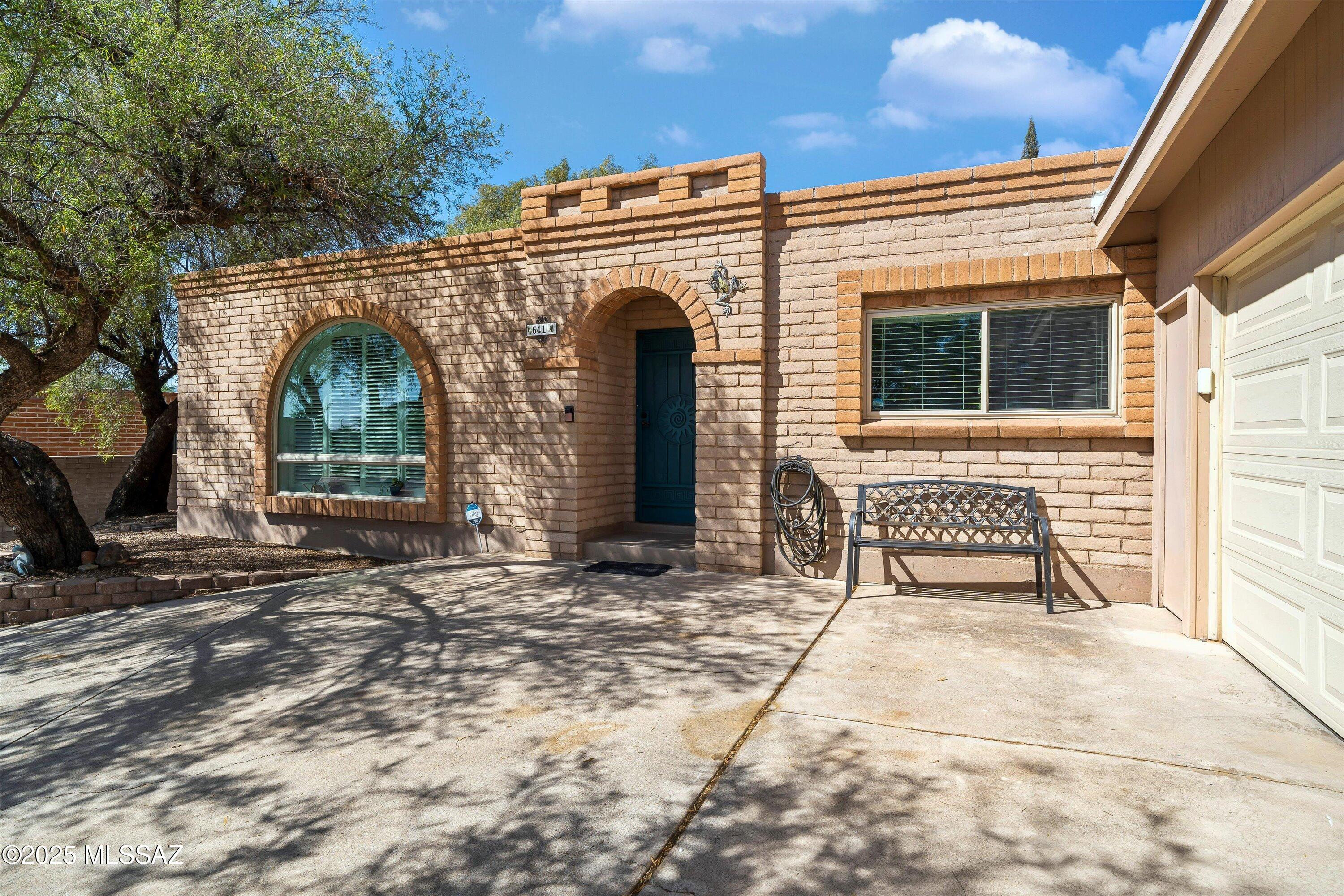 Don't miss this beautifully updated ranch-style home with modern touches thru-out! The remodeled kitchen, completed in Jan '25, features quartz counters, upgraded cabinets, stainless appliances and opens to a bright dining area. French doors open to the covered patio extending the full length of the home and easy-care yard. New luxury vinyl plank flooring flows thru-out the home. The spacious living room is warm and inviting. The expansive primary suite includes an en suite bath, walk-in closet, and private patio access. Bedrooms 2 and 3 are also generously sized. Both bathrooms are stylishly updated.  AC and furnace recently replaced, custom shutters,  and TEP solar panels with fixed $77.88/mo loan payments for 16 years complete this move-in ready home!