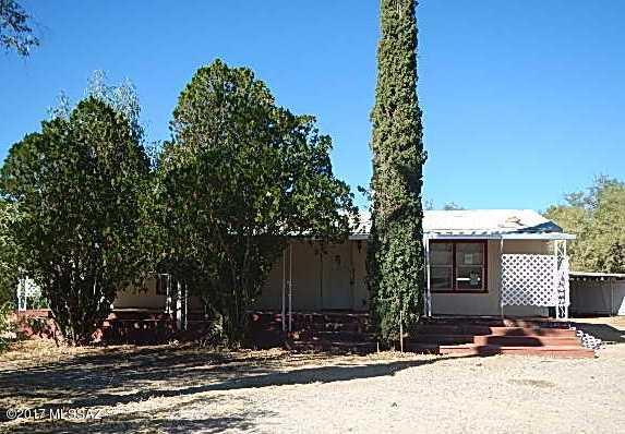 Rural, Country setting with mountain views. 2 bedroom, 2 bathroom home sits on 1 acre of land. Home has covered porches at front and rear of home and 2 car carport. Completely fenced in with lots of mature trees.