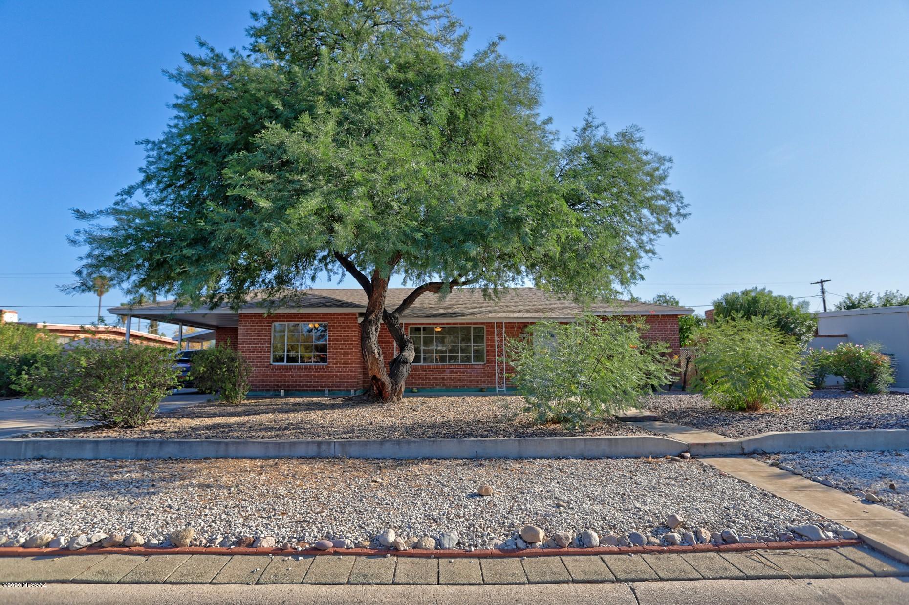 Terra Del Sol - land of the sun! Great community feel in this established east-side neighborhood. Solid wire-brick construction of the 50's, charm of crank windows & a picture window in the living room to watch the activity makes this home a warm reflection on days gone by! But wait, the inside is today's modern look with remodeled kitchen, bathrooms, fresh paint, newer roof, and tiled through-out (NO CARPET). Upgrades include: new bathroom vanities, sinks & toilets, resurfaced surrounds & tub, kitchen has maple cabinets, granite countertops & stainless appliances, laundry has a full sized stack unit (washer & dryer included). This 3 bdrm. plus den has good space.