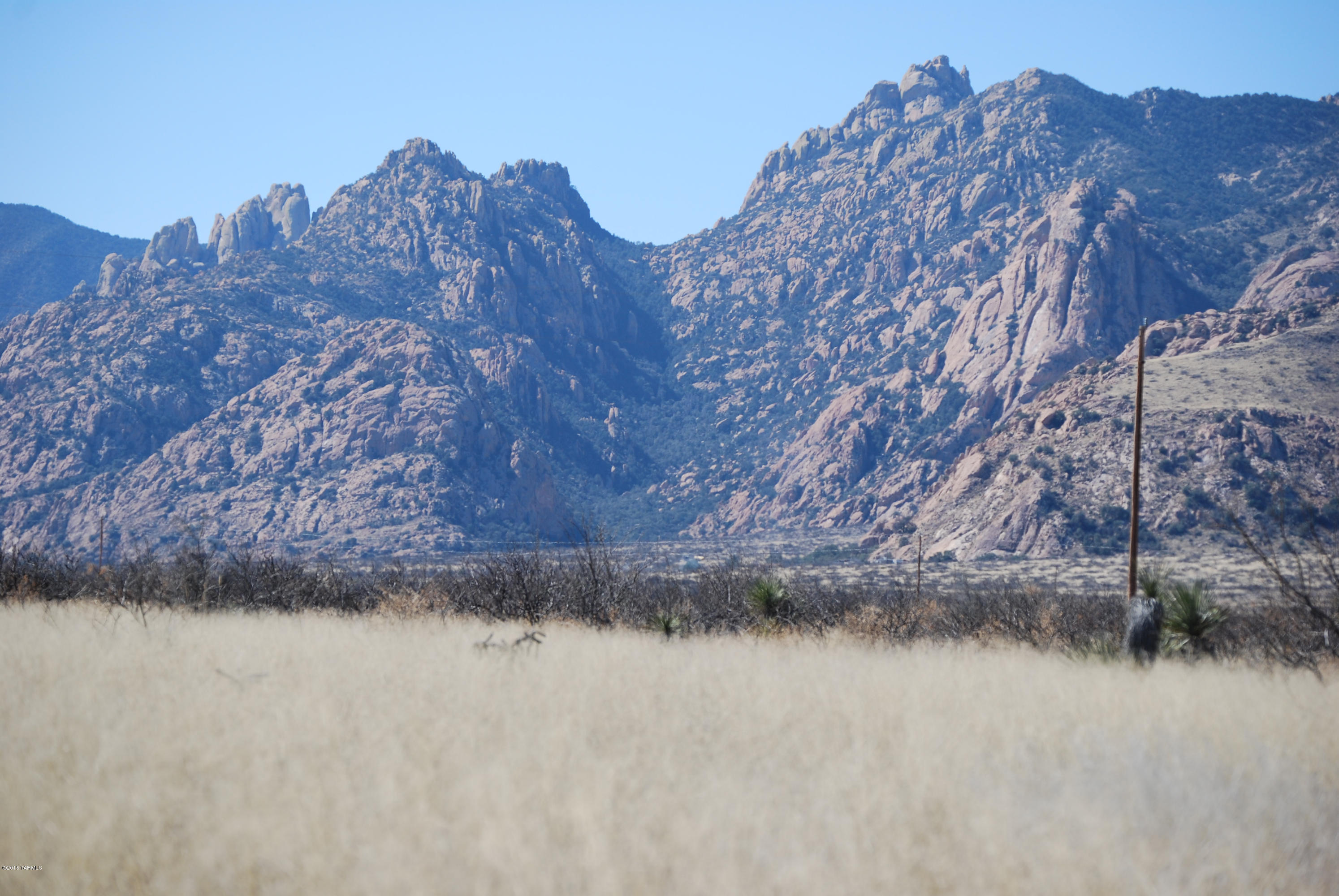 Tremendous Views of Cochise Stronghold & the Dragoon Mountains from this 40 acre parcel. Electric & phone run along the entire southern boundary of the property (Dream Catcher Way) & to the north approximately 1/8 mile (Slope Along Way). Near Pistachio Groves Vineyard. Numerous custom homes in the area. Seller is flexible and will look at carry back or reasonable exchanges. North 40 acres is available for $55,000. Entire 70 acres available for $120,000  Ten acre parcels availlable for $18,500
