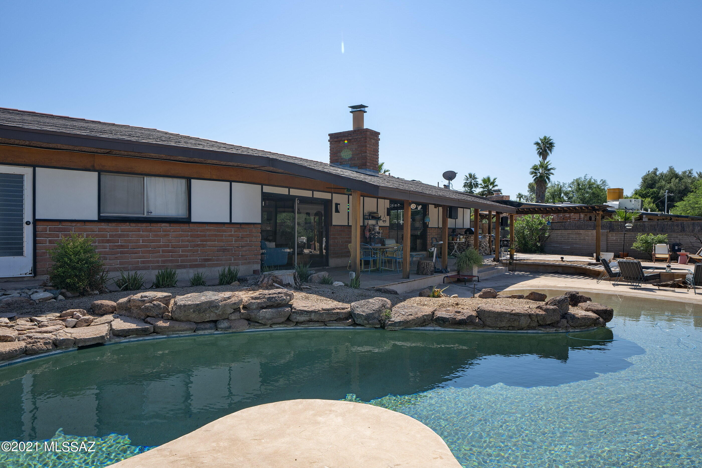Seller will accept or counter  offers between $500,000 and $530,000. Built, in 1963, .53 acre lot, 2647 sq ft Mid Century home has a beach entry pool, spa, and is an entertainers delight. 4 Bedroom 2.5 Bath. Private foyer entry with shoji screens.  Kitchen has stainless steel appliances. Formal dining room with reclaimed chalk board floors, bamboo wall paper and original mirrored accent wall.  Step down into a sunkin living room or open the wall of shoji screens to create open living spaces.  Recently added cork flooring, wonderful built ins, ample storage and great closet space. Smart home technology.  Outdoor living with pool, spa, firepit, built in BBQ and wonderful covered porch.  10 X 14' BOMB shelter with fresh air intake fan. Backs to wash for privacy. RV hook up MUST SEE!