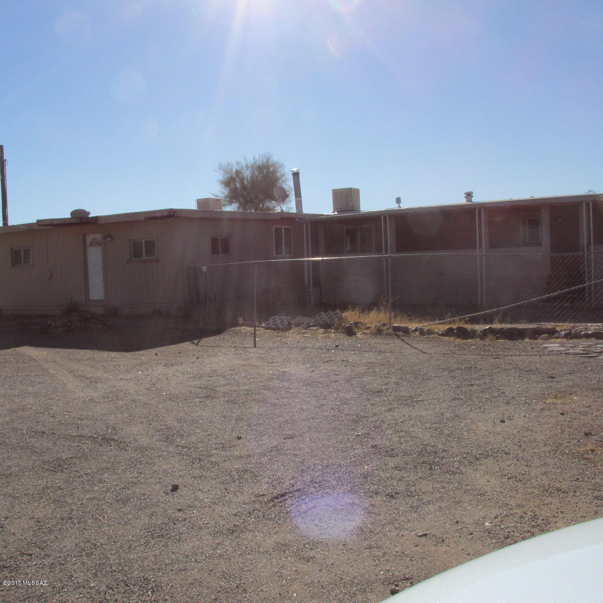 HAS 14X66 1982 MOBILE HOME WITH ADDITIONS, IN ''AS IS'' CONDITION, SITTING ON ALMOST AN ACRE. ALL FENCED. HAS 2 STORAGE SHEDS. HAS 1200 GAL SEPTIC, SET UP FOR ANOTHER MOBILE HOME WITH 200 AMP ELECTRIC SERVICE