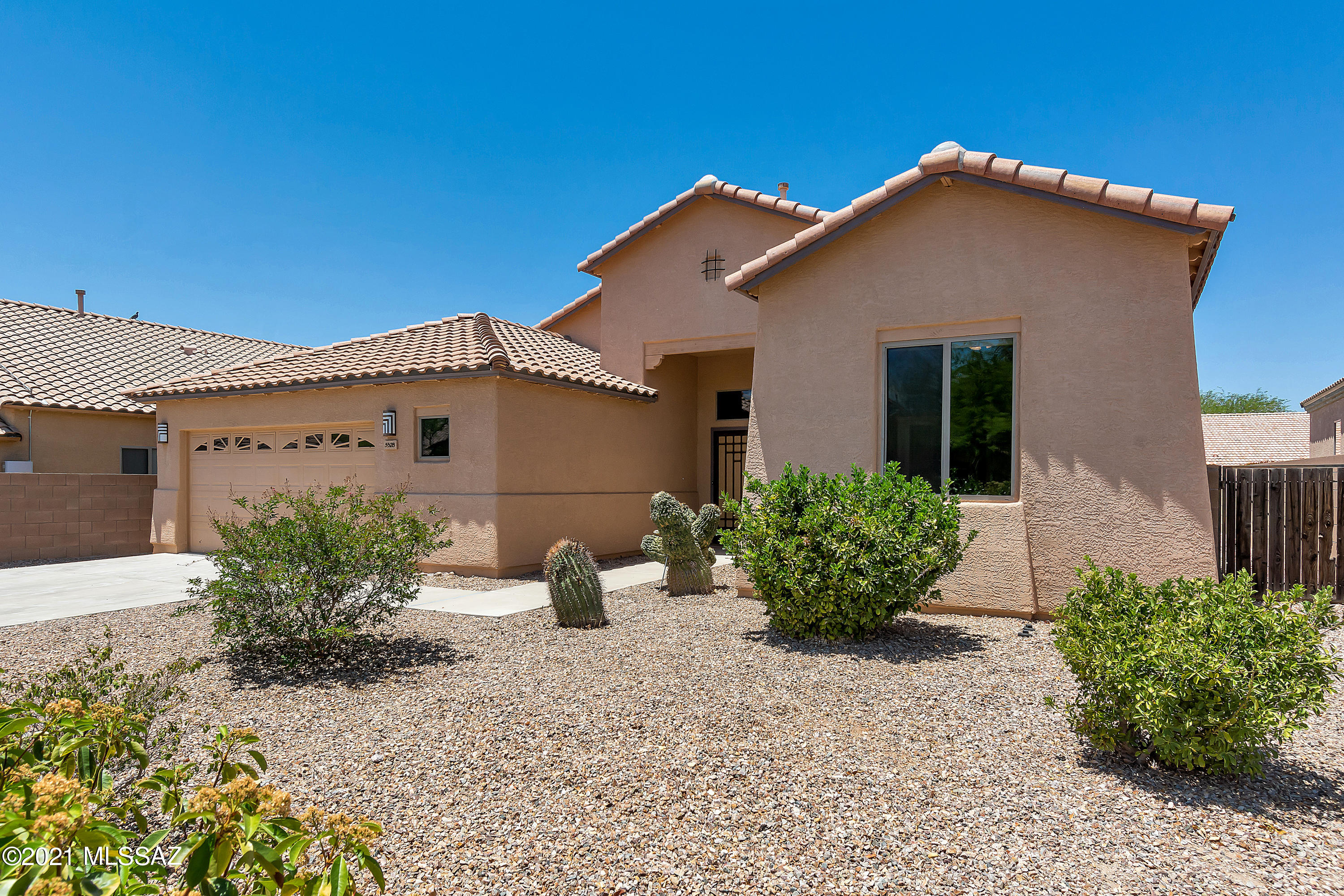 Welcome to the sought after Community of Tucson Mountain Sanctuary! Nestled at the base of the Tucson Mountains sits this move in ready home with high ceilings and plank porcelain tiles throughout the main living space. Kitchen overlooks the living area, leading to the back patio. Ample outdoor space provides an entertainer's dream, with flagstone pavers, a putting green and a built-in firepit with seating. Positioned on a larger lot, allows for the extended driveway. Welcome home, to all that Southern Arizona has to offer!