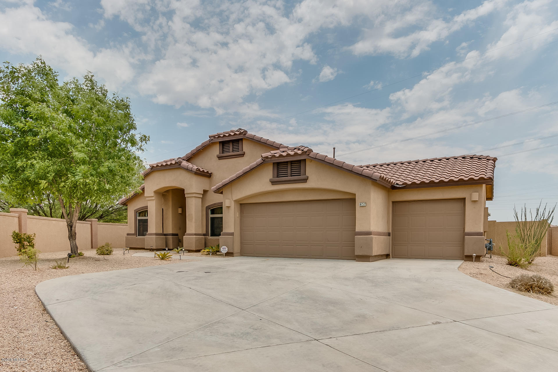 Come enjoy all the amenities that the award winning Rancho Sahuarita community has to offer in your own private retreat! This beautiful 4 bedroom home is privately situated on an oversized corner lot with no rear neighbors. As you approach the property you will appreciate the red tile roof lines and mature low care landscaping. Enter through an open concept living and dining space to your spacious kitchen complete with a generous walk in pantry. Continue to your large living space overlooking your outdoor oasis. With a built in BBQ, green space, private pool, and hot tub there is plenty of space for entertaining. Retreat to your large master suite complete with a soaking tub and walk in closet. With a 3 car garage and extra storage this Rancho Sahuarita gem is sure to please. Welcome Home!