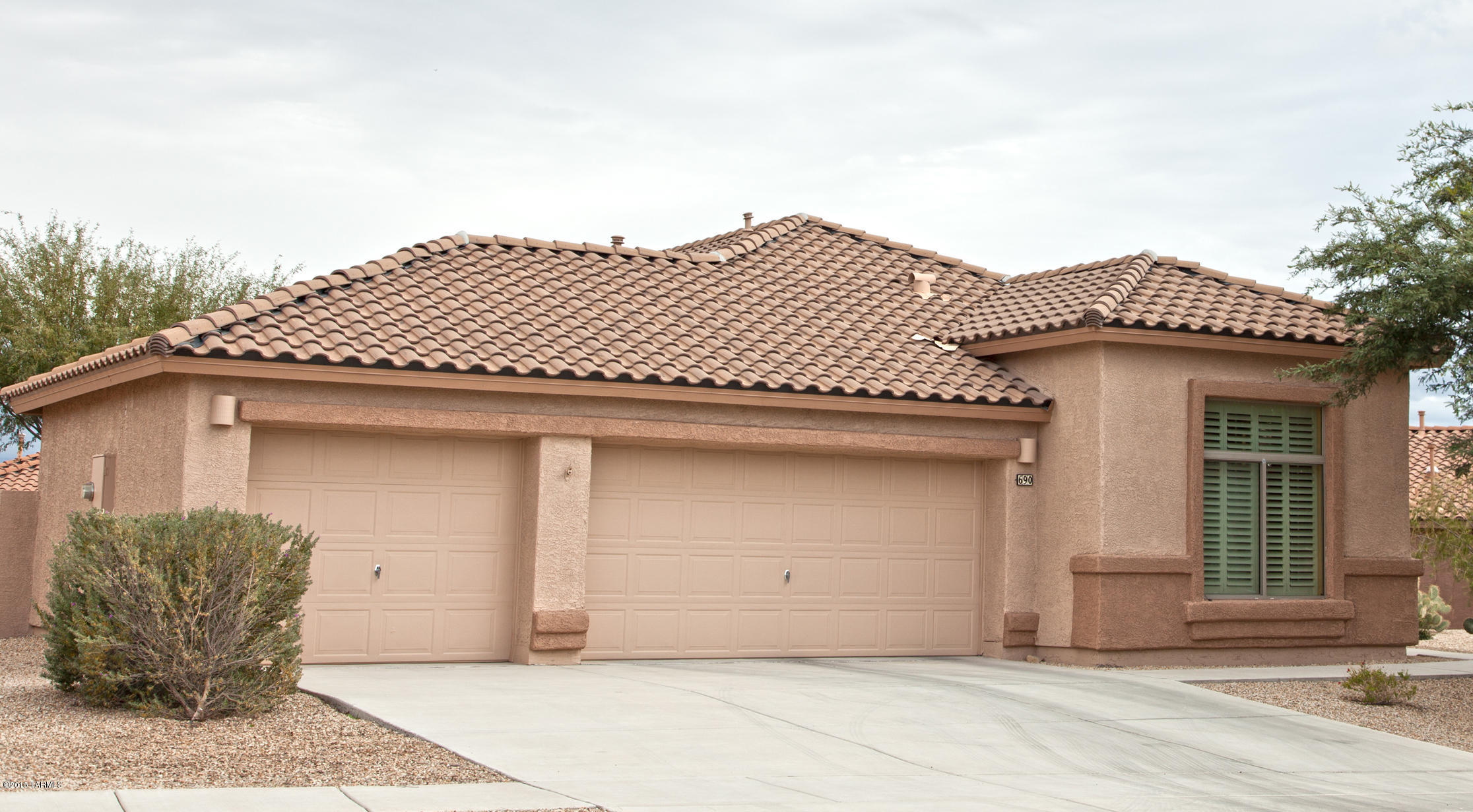Enjoy beautiful mountain views from this lovely 3BR/2BA home in the Traditions of Desert Creek. This gorgeous DR Horton Coronado model home features a much desired 3 car garage for all your toys.  An open floor plan with decorative colors, fireplace & tile floors. Upgraded Master bathroom with dual sinks & walk-in shower. Utility room, covered patio and beautiful desert landscaping in both front and back brings this home together as a home to enjoy for years to come!! Located close to shopping, dining, Green Valley Recreation and social centers and more!!