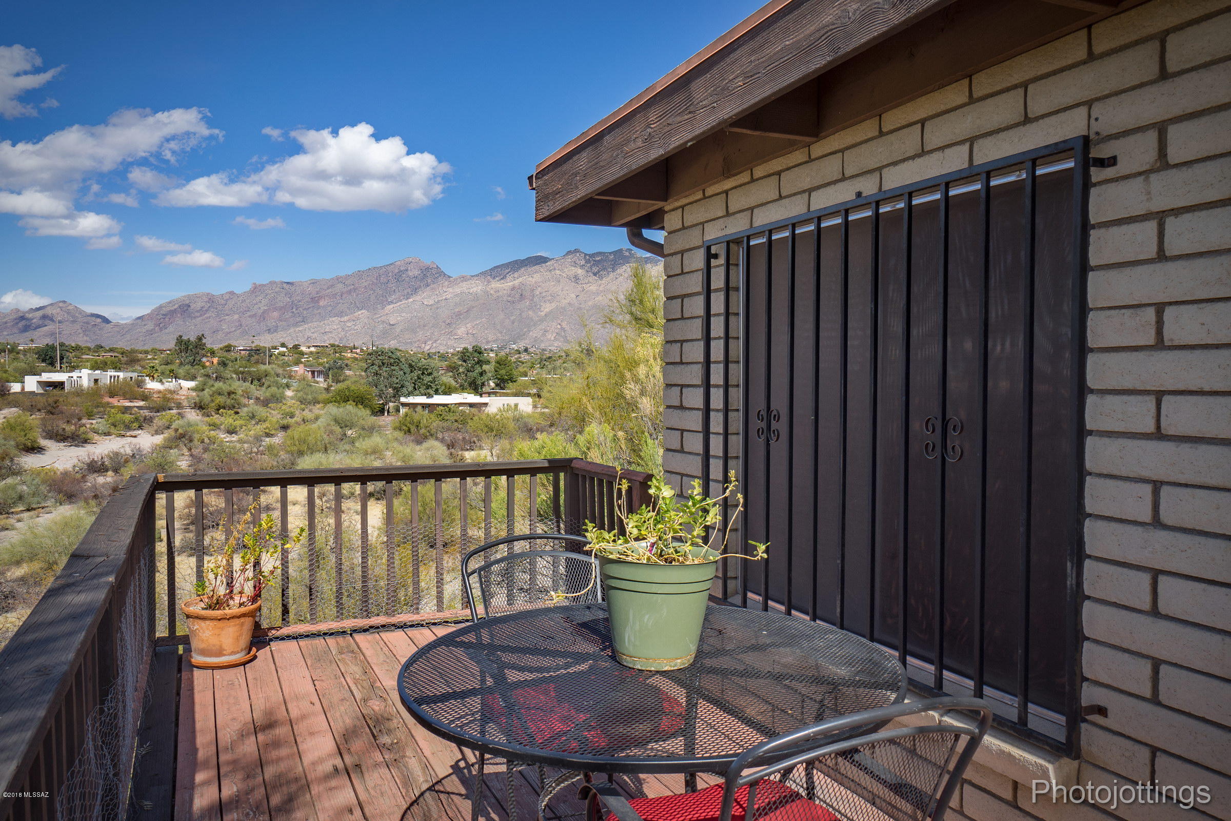 LOCATION, LOCATION, LOCATION! This is a great opportunity in the Catalina Foothills with city and mountain views! Sitting on over 1.6 acres and with an attached 400 sqft guest house (with full kitchen!), this is a rare opportunity! This home is in great shape and just needs some TLC and an owner with a vision for modernizing this home. This is an original owner sale and this home is a real gem in the rough: spacious, well-located, and priced just right! This property features a formal living/dining room and family room with a charming fireplace off the kitchen, which features city and mountain views. The hallway and master bathrooms have newer vanities with quartz countertops. Large driveway with lots of parking and on a cul-de-sac. Don't miss the opportunity to make this home yours!