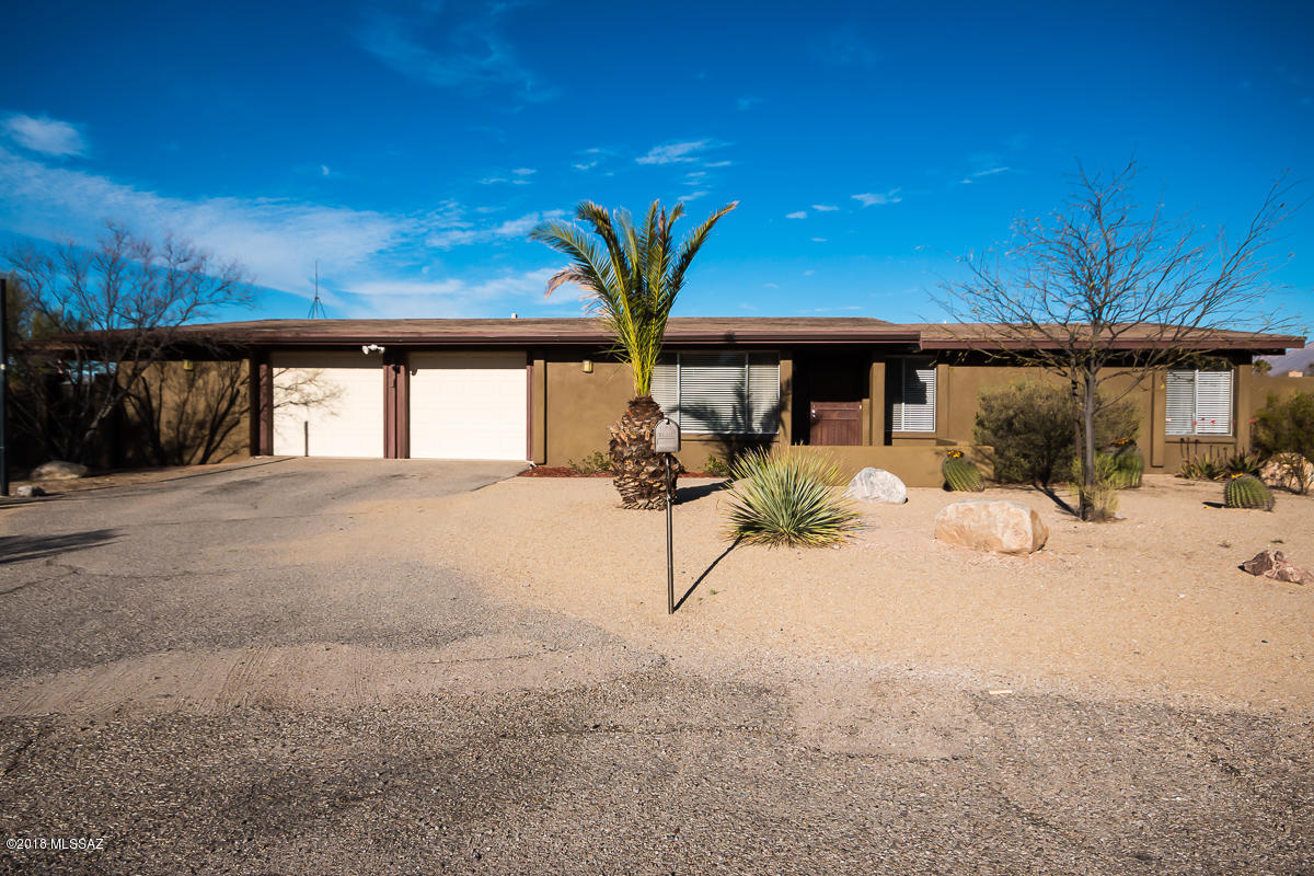 Desirable ranch style home nestled in a cul-de-sac just minutes away from the base of Mt Lemmon! Incredible views of the Catalina Mountains, so close you feel like you could touch them! Great sized bedrooms, Living room and cozy family room with fireplace is great for entertaining. Updated bathrooms (1/2 bath with shower/sink is located in bedroom 4 for a great suite). Recessed lighting throughout. Nice open kitchen to formal dining area, with stainless steel appliances. Huge garage offers workshop space, laundry room, & lots of storage! All appliances are offered with this great home!  Huge yard is a show stopper with lots of covered sitting areas, green grass, double gate, rain capture system & relaxing Spa. Seller will accept or counter offers in the range pricing of $290,000 to $320
