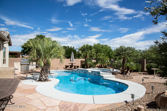 Exterior was just freshly painted this Feb! FANTASTIC price for this UPGRADED 3 Bedroom, 2 1/2 Bath home on the Golf Course w/Mountain Views, a Pool w/spill-over Spa & a leased Solar System! It's virtually your own resort within Quail Creek! Kitchen boasts tiled back-splash, tumbled stone across kitchen, under cabinet lighting, lower cabinet Roll-Outs, Gas Range & Wet Bar. The Family Room, adjacent to the Kitchen, is wired for speakers & has a Gas Fireplace. The Master BR has a Bay Window w/a slider to the screened-in porch which has ceiling fans & additional lighting, 2 walk-in closets & the Master Bath has updated shower & Jacuzzi surround. The 3 Car EXTENDED Garage, has epoxy coated flooring, built-in cabinets, workbench, utility sink & over-head storage. Ceiling Fans thruout the house