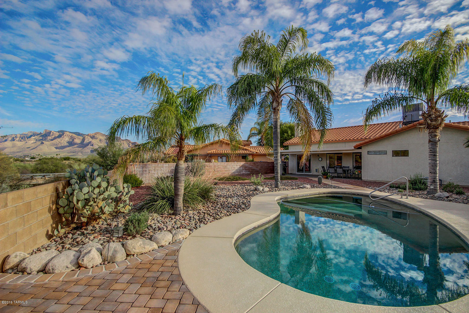 Mountain views! Beautiful 4 bedroom 2 bath home. Resting on large lot that backs up to desert for the ultimate in privacy. All NEW Tile Flooring! Open and updated kitchen with granite counter tops, and center island/breakfast bar. Enjoy the cozy fireplace while cooking an amazing meal. Spacious master suite with remodeled bathroom, garden tub, separate shower and walk-in closet.  The backyard oasis is perfect for entertaining. Sparkling pool, low care landscaping and the views! Walking distance to park and walking trails. A great family home. Come take a look.