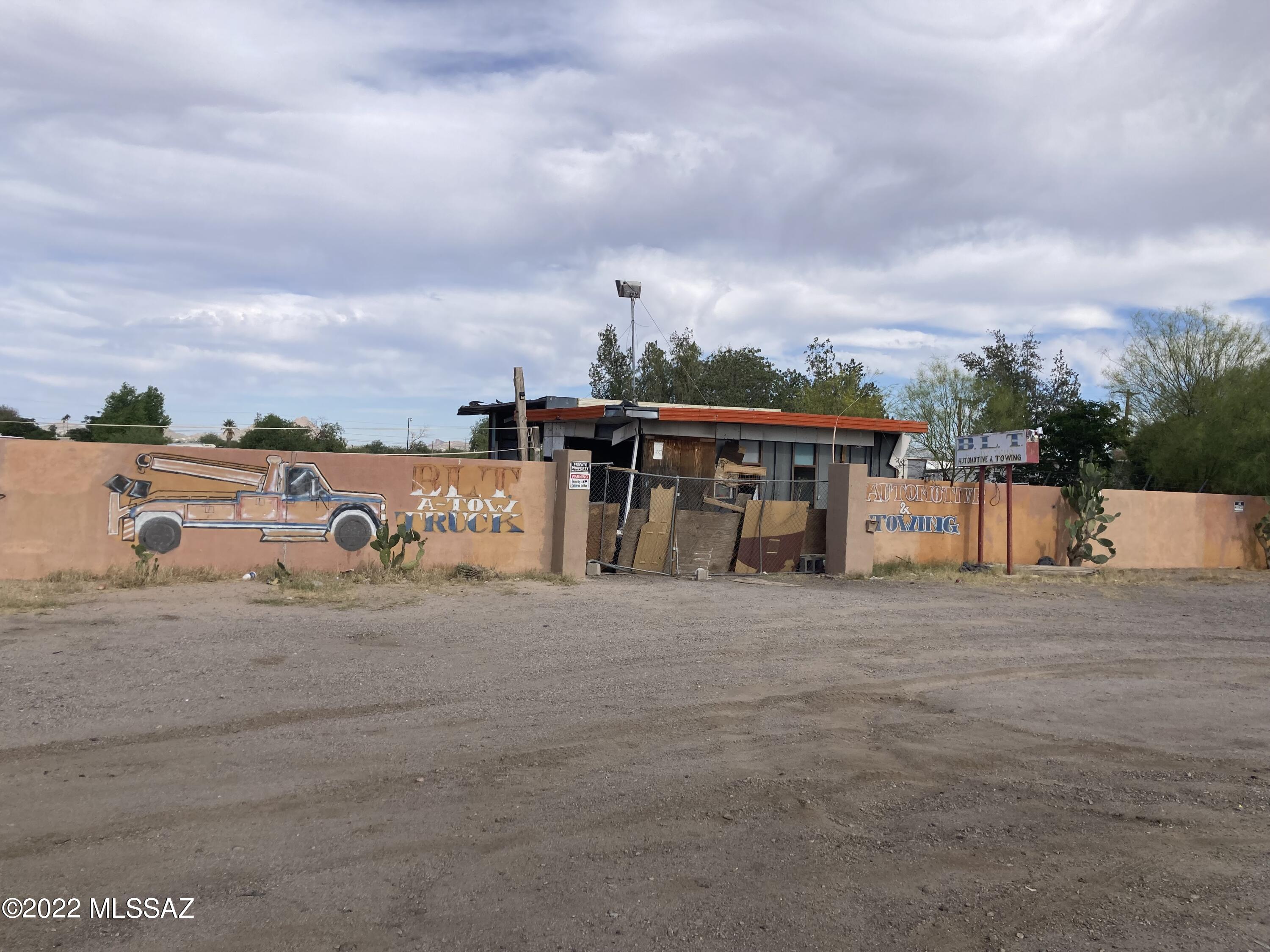 1.235 acre lot on Nogales Hwy - zoned C2 - has been auto repair/yard - two buildings on property are unusable.  Lot needs clean up, then ready for a thriving business.  Industrial/commercial area - convenient  area of Tucson