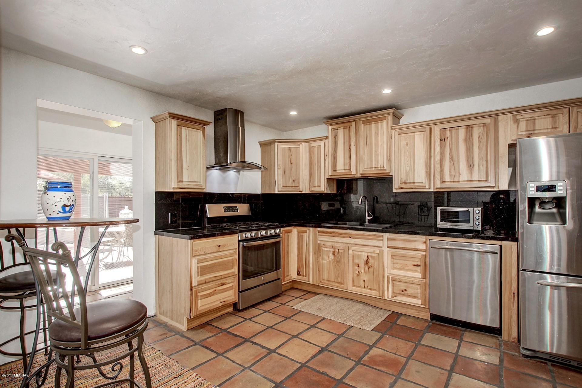 Awesome remodeled kitchen with hickory wood cabinets, granite tile counters and back splash. Stainless steel appliances compliment this eat in kitchen. All tile floors. Bathrooms remodeled with new vanities. New tile shower in one bath. Exterior newly painted. Lots of natural light in the North South facing home. Split bedroom floor plan, separate wing is great for guests, mother in law quarters or roommates. LARGE YARD with pool. WIDE DOUBLE carport. Workshop area and storage. Mature trees in back with charming sitting area. Broadmoor Beauty!