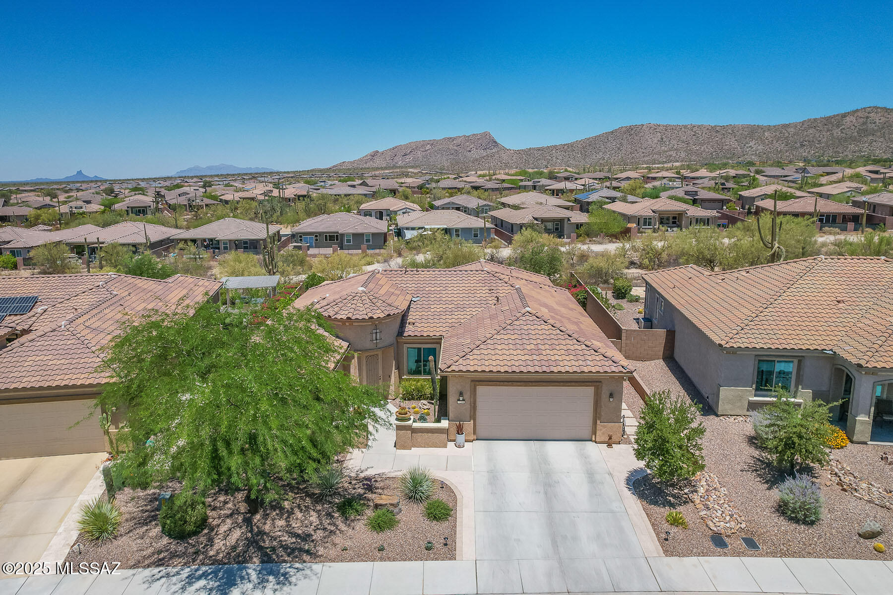 Welcome to this stunning 3BD/2BA+den (2337 sq ft) thoughtfully designed living space, located in the highly desirable Del Webb at Dove Mountain active adult community.  This sought after Serenity model showcases numerous high-end upgrades throughout, including a stylish glass inset front door, custom lighting, elegant window treatments, upgraded flooring and more. Step outside to your private desert oasis professionally landscaped with a spacious pergola, built-in stone fireplace and BBQ, turf area perfect for yard games or relaxing in the Arizona sun. Enjoy breathtaking Tortolita Mountain views and unforgettable Dove mountain sunsets from your own backyard. Del Webb residents enjoy a wealth of amenities, including resort style pool, fitness facilities, pickleball courts, and more!