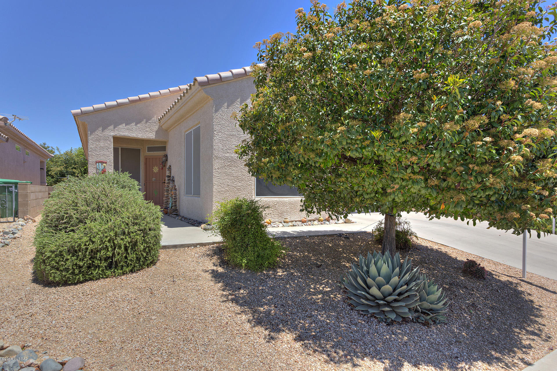 This house is a MUST SEE with lots of pluses! Mature landscaping is already in place in both the front and backyards. You'll love that it has a security screen front door that you can lock and let the fresh air in! Inside, a Great Room! It's that open floor plan you're looking for!  The guest bedroom is separate from the Master Suite area. The office is behind double doors it has a Murphy Bed so it can be a guest room. There's a dining area that can handle your large table and a hutch or cabinet. The kitchen has more counter space than you'll ever need and lots of cabinets, too! If the kitchen is important, you need to take a look! There's a gas range, tile countertops with under cabinet lighting, double sink, pantry closet and a long breakfast bar. Beautiful tile floors! The bedrooms and office floors are carpeted. You'll be amazed at the size of this Master Suite with bay window and Hunter Douglas blinds and ceiling fan. The Master Bath has everything! Two separate cultured marble vanities, a garden tub, and separate shower. There is a walk-in closet and a wall closet.

The laundry room is inside with the washer and dryer included in the sale. A large 2 car garage that offers plenty of space and room for storage includes a water softener.

This house has everything you need whether year 'round or as a winter home. You will see the value! Be the first to check it out! You'll be glad you did!