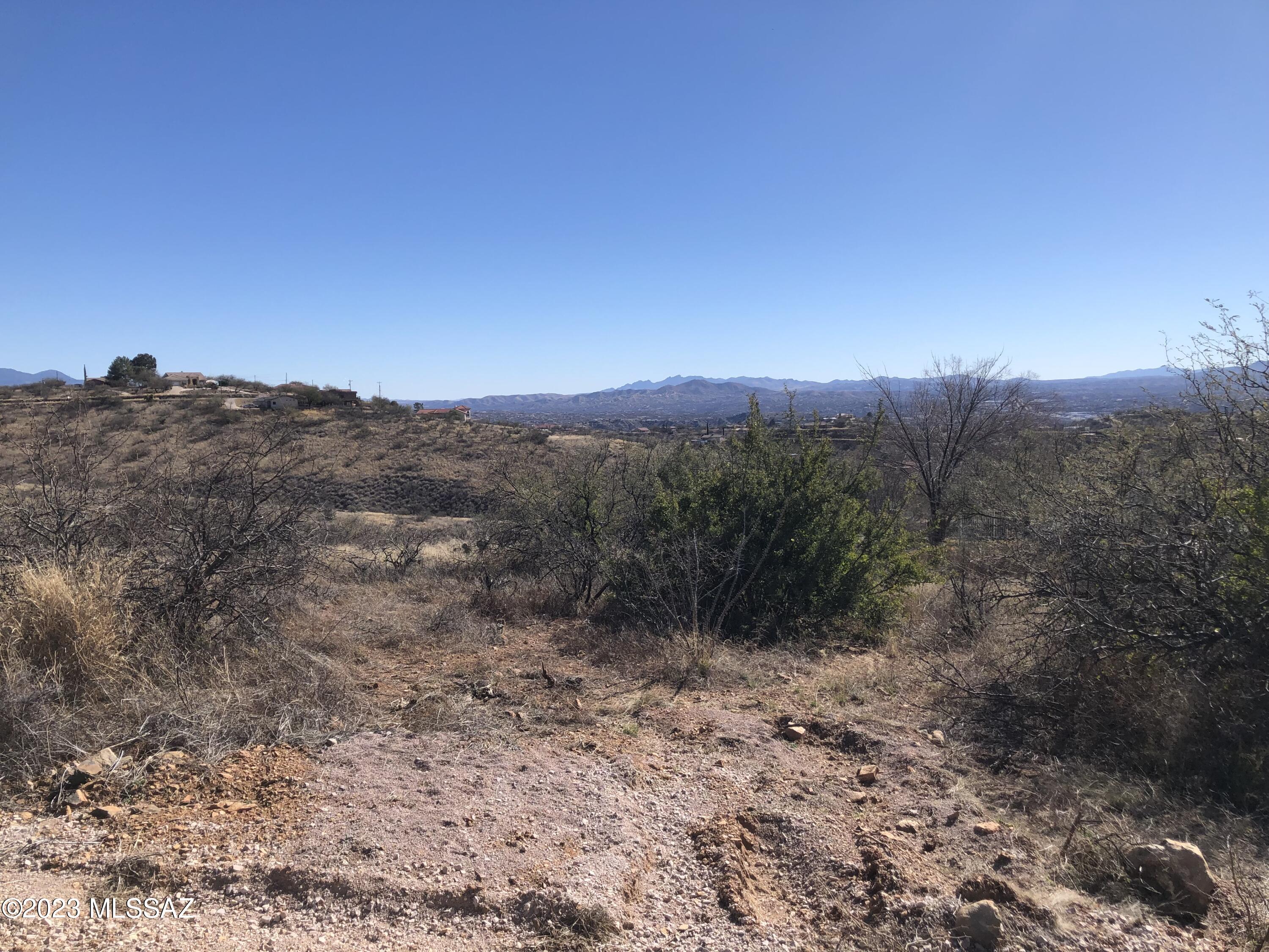High up views.  Lot is mostly downhill sloping, will take some dirt work to create the building pad.  Electric and water are at the street.  All paved road access.