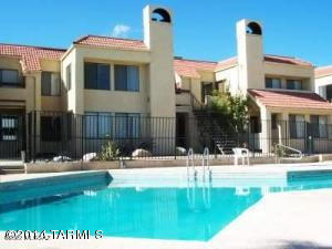 This 2BR/ 1BA downstairs condo is absolutely perfect for a Couple, Single, Student or Winter Visitor. On the West side of Tucson its snuggled in the back close to the pool. Great room is open to kitchen, eating area and family room with fireplace. French doors lead into the first bedroom that has walk in closet. Small patio and storage are off sliding glass door.  Other bedroom has 2 closets. Unit comes with 1 covered parking space.