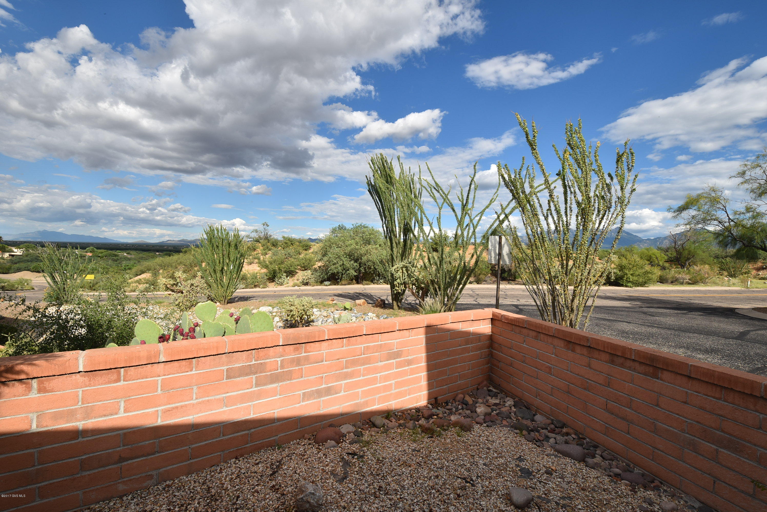 Looking for a turn key fully furnished winter get away? Then here it is! Enjoy carefree living in this beautiful move in ready townhome in Desert Hills with Santa Rita views to the east from back patio.
 Bright 2 bedroom/2 bath with ceramic tile everywhere except bedrooms. Split bedroom floor plan with a large master suite with huge walk-in closet, ceiling fans. Spacious 2 car carport. Nice covered patio with fenced yards with storage area. All appliances stay. New HVAC heat pump in 2017. Roof coated in 2015. All furnishings available (even the bicycles!) under separate bill of sale. Call agent for details. Don't miss this!