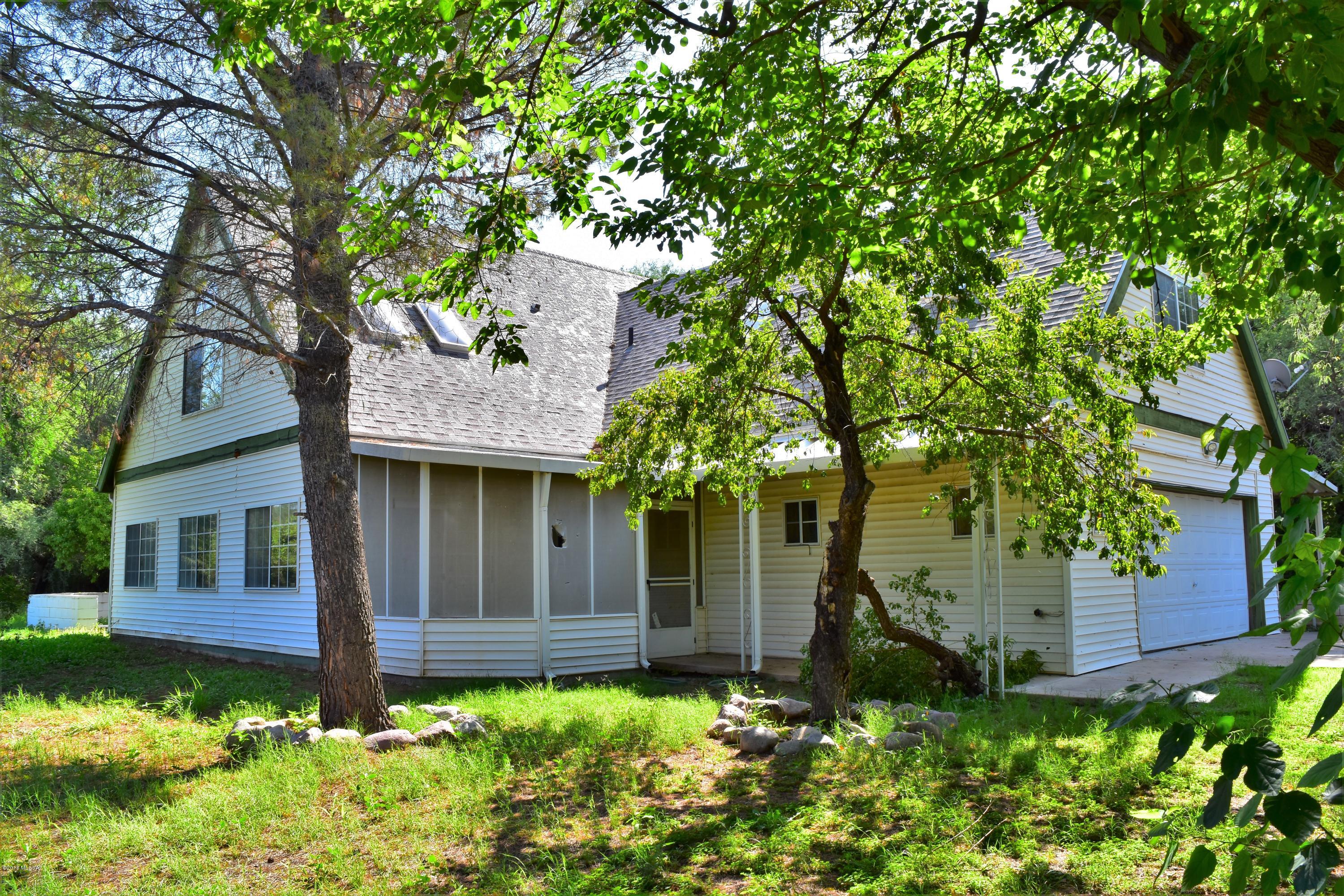 Unique, roomy 2 story on corner lot in Rio Rico. A-frame roof allows for 2 bedrooms and 1 bath upstairs. Large family room addition designed for private playroom or man cave with separate HVAC and entry doors. Totally fenced large back yard with patios and large storage shed. Make your appointment to see today!