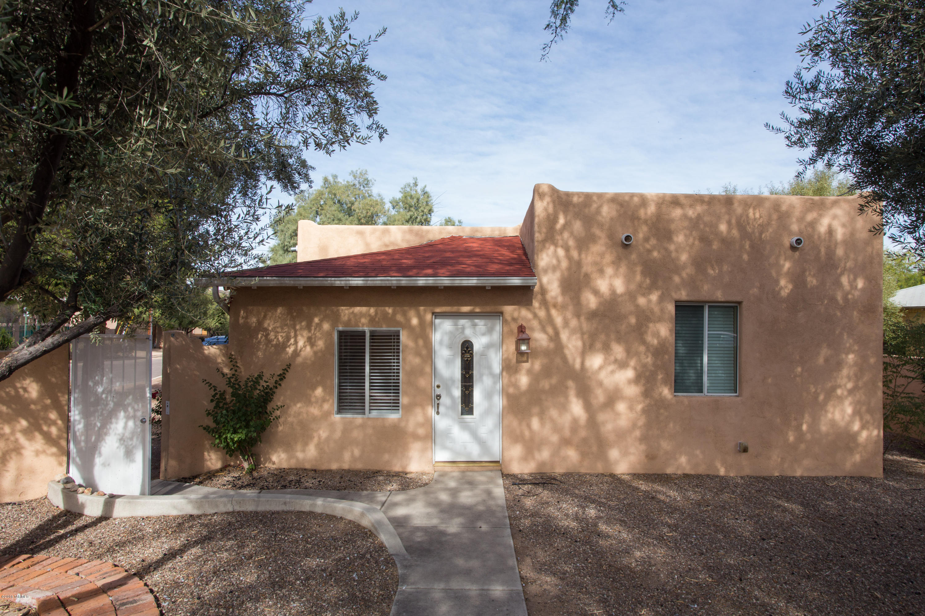Midtown Charmer! Delightful midtown home conveniently located on a corner lot just minutes from Speedway & Alvernon. This immaculate 3 bedrooms 2 bath home also has a guest house. Completely walled and separate front and back courtyard spaces. Updated kitchen and master bathroom. Gorgeous hardwood floors in two of the bedrooms and tile throughout the rest of the home. Back patio is perfect for entertaining with room for a grill and seating area. Extra storage building in the back courtyard. HVAC unit is less than 1 year old. Added bonus of a grapefruit & lemon tree!