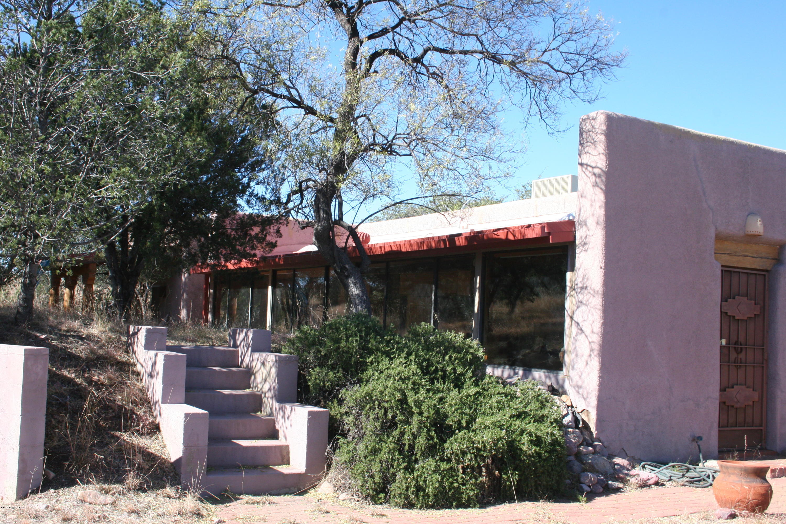 PRICE REDUCTION! A wondrous setting in the coveted community of Casas Arroyo De Sonoita, 2,321sf adobe, 3BR/2BA. Charm and character describe this custom private retreat (full time or part time) with the best of country living.  Custom  tiles, brick floors, Sun Room, and extraordinary views from deck.  The subdivision is replete with 200 acres of community open space providing endless walking and privacy and community pool. A short distance to Hwy 83 to Tucson, Hwy 82 to Sierra Vista or Nogales. Near the areas renowned wineries, tasting rooms, Santa Cruz County Fairgrounds for numerous community events, great local restaurants and all of the best of country living. Less than 50 min. from Tucson Int'l Airport. Easy to leave, easy to come home to - LIVE THE DREAM!
