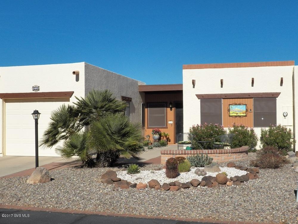 Cozy well-maintained 2BR 2BA townhouse in popular Desert Hills area. As you enter the home your eye is drawn to the red brick fireplace creating ambiance and warmth to the living/dining area. The floorplan is very compact with the kitchen, breakfast nook and laundry so easily accessible. The rear covered patio faces a greenbelt, while the front patio offers an excellent view of our 10,000 ft mountain peaks. Transferable roof and termite warranties. New water heater in 2016. Newer HVAC with an annual service maintenance contract. In close proximity to the rec center.