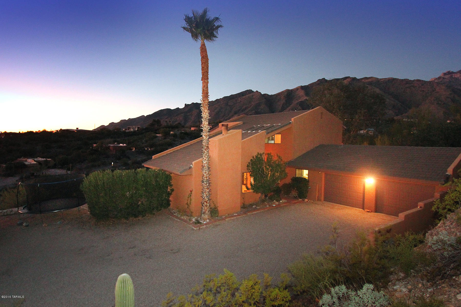 Just REDUCED. Priced to SELL. Priced under others in the neighborhood. 3 Bedroom/2 Baths-large rooms. Well cared for and it shows! Unique and Beautiful setting! Foothills home w/mesmerizing views. City lights and Catalina Mountain 360 degree views from every window. Multiple Large Patios and yard space + in ground spa. Custom architect designed Cimarron Etsates is private atop over 2 acres. Located in the sought after District 16 schools. Kitchen with custom cabinetry & double ovens. Kitchen & nook just repainted. Split Bedroom Plan. Master Suite enjoy peace and privacy. Master includes sitting room, 2 huge walk-in closets and large patio. Master bath with custom Xlarge shower with dual shower heads. Wood ceilings. Refreshing Hot Tub with Views! Oversized Garage with workshop. Welcome Home