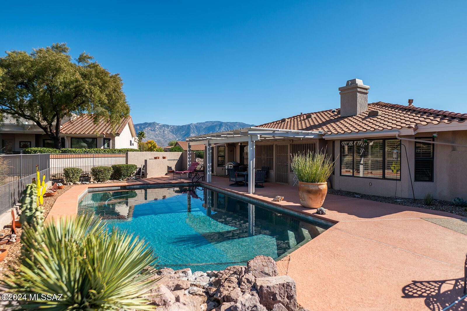 This delightful home, located on a spacious corner lot, offers a perfect blend of comfort and outdoor living. The kitchen has plenty of counter space, and cabinetry for storage. Adjacent to the kitchen is a cozy dining area, with a view to the pool, perfect for family meals, or intimate gatherings. Both bedrooms are generously sized, with the master suite offering its own private bathroom, the second bedroom, has a Murphy bed, with built into custom cabinetry, perfect to maximize space without sacrificing comfort, it can also be used as an office. The true highlight of this home is the outdoor space. The backyard is a private oasis, complete with a sparkling pool-perfect for enjoying sunny days and hosting parties. Close to local shops, and restaurants.
