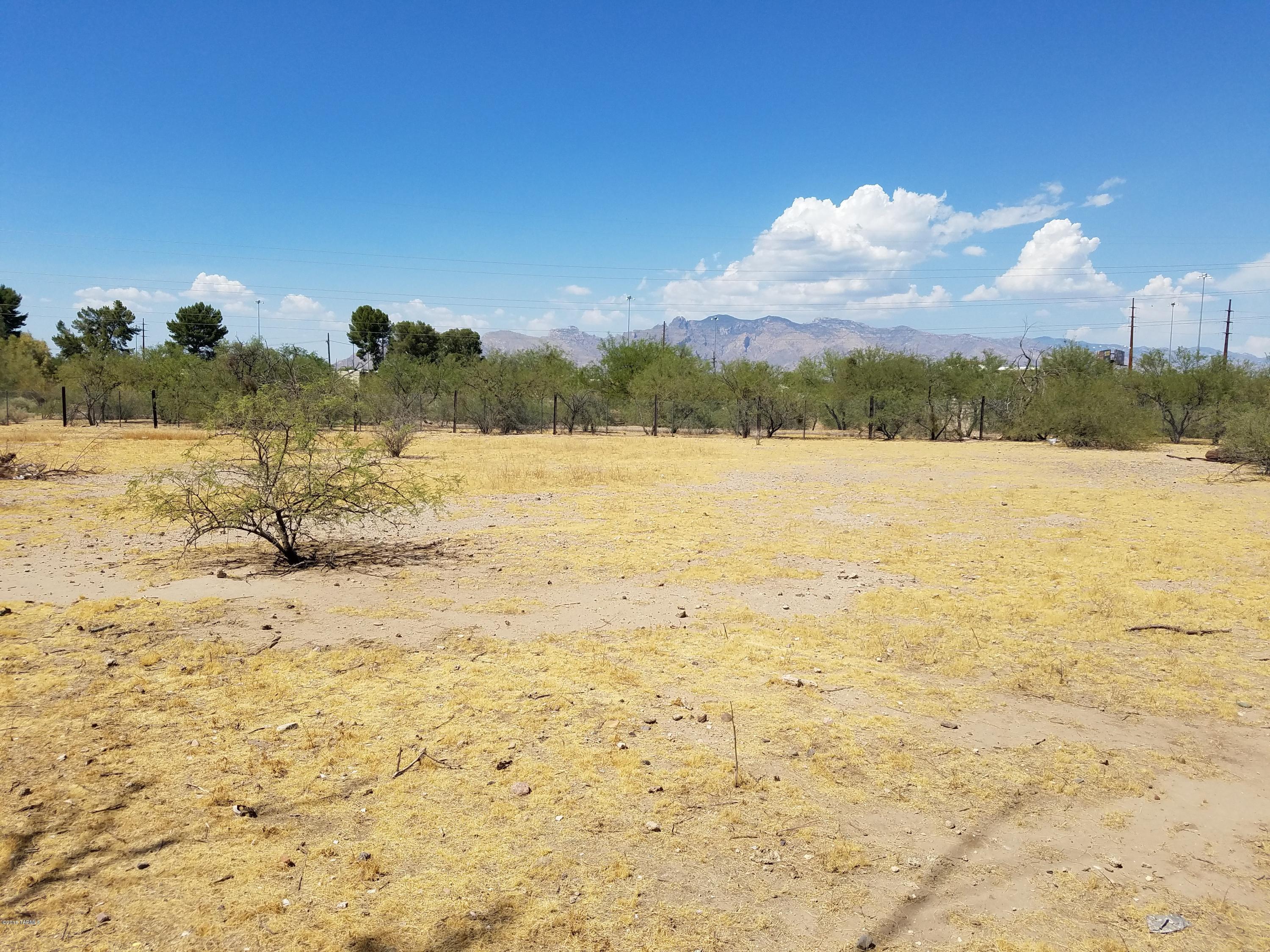 Seller will accept or counter offers between $60,000-$70,000. A great U-shape flat piece of land with unobstructed mountain views. Located behind El Rio Golf Course. Very private by the end of the subdivision. This is a premium lot surrounded by the Santa Cruz River Park. Great opportunity for an investor/developer. Fenced house in the middle is not included. Amazing opportunity! MOTIVATED