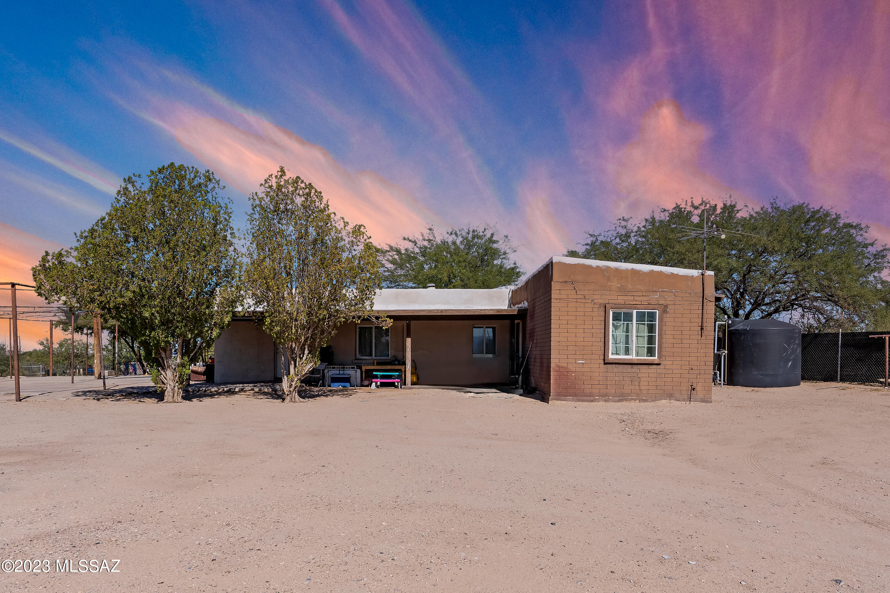 Great Opportunity to Own this 1-Acre Property with NO HOA! With the large size of the lot, there are plenty of options to set up the perfect entertaining space and enjoy hosting large gatherings. The Home Features 3 Bedrooms, 1 Full Bath, 1,695 SqFt with an additional storage structure. The location is minutes away from Valencia Rd heading North and Sahuarita/Green Valley heading South. The property is ready for it's new owner! Property being sold in ''as-is'' condition. The property is on a hauled water source. Water Storage Tank is 2,500 Gallons.