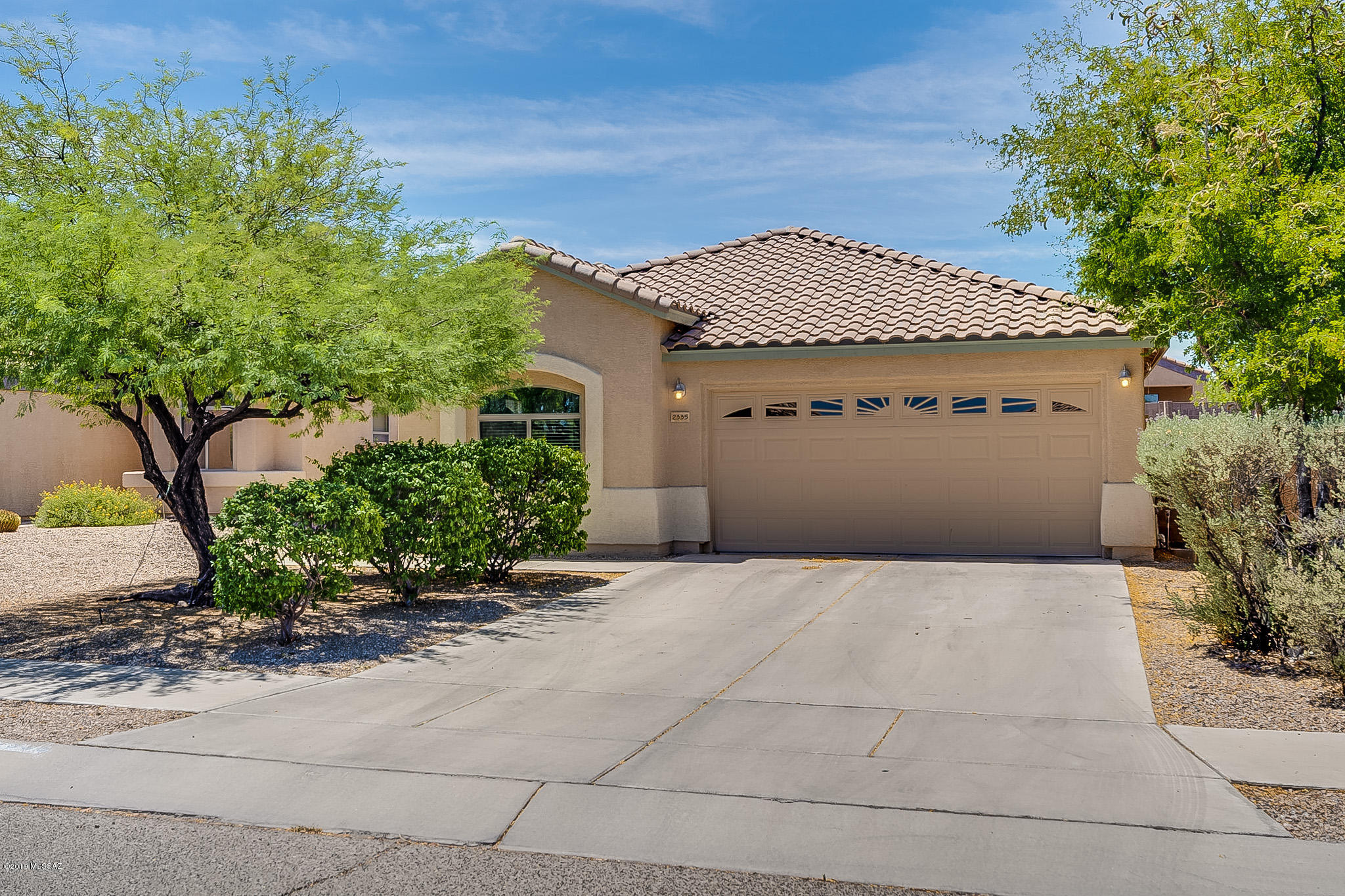 Shows like a model.  Newer air conditioning, upgraded kitchen countertops, cabinets and lighting.  Island with Breakfast Bar, Stainless Appliances, walk-in pantry, and refrigerator, washer and dryer stay.  Huge great room pre-wired for surround sound.  Split bedroom plan.  Master features executive height counters with double sinks, and his and hers closets.  Extended patio wired for ceiling fan, big yard with bbq and a dog run.  Finished 2 car garage.  Minutes from Pima Community College, University of Arizona, Downtown, Shopping, Walking Trails, Parks, Restaurants, I-10 and bus line.