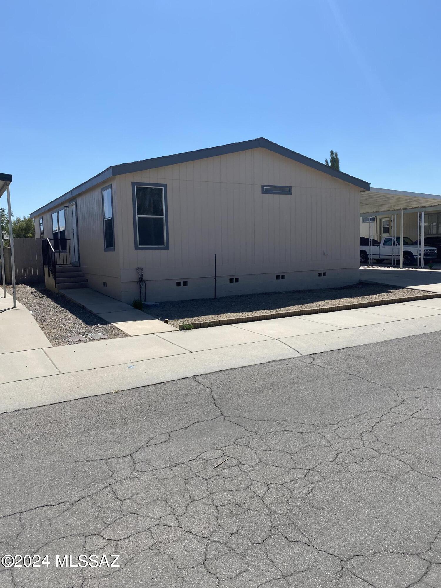 This Nicely updated manufactured home is in a gated subdivision. It features new cabinets, new counter tops, new stainless steel appliances, new flooring, new bathroom vanities and fixtures, ceiling fans through out and freshly painted inside and out. It has 3 bedrooms, 2 bathrooms, laundry room, carport, & low maintenance back yard, shed. Located close to I-10, shopping, entertainment, restaurants, Tucson Mall, and much more! Owner/Agent