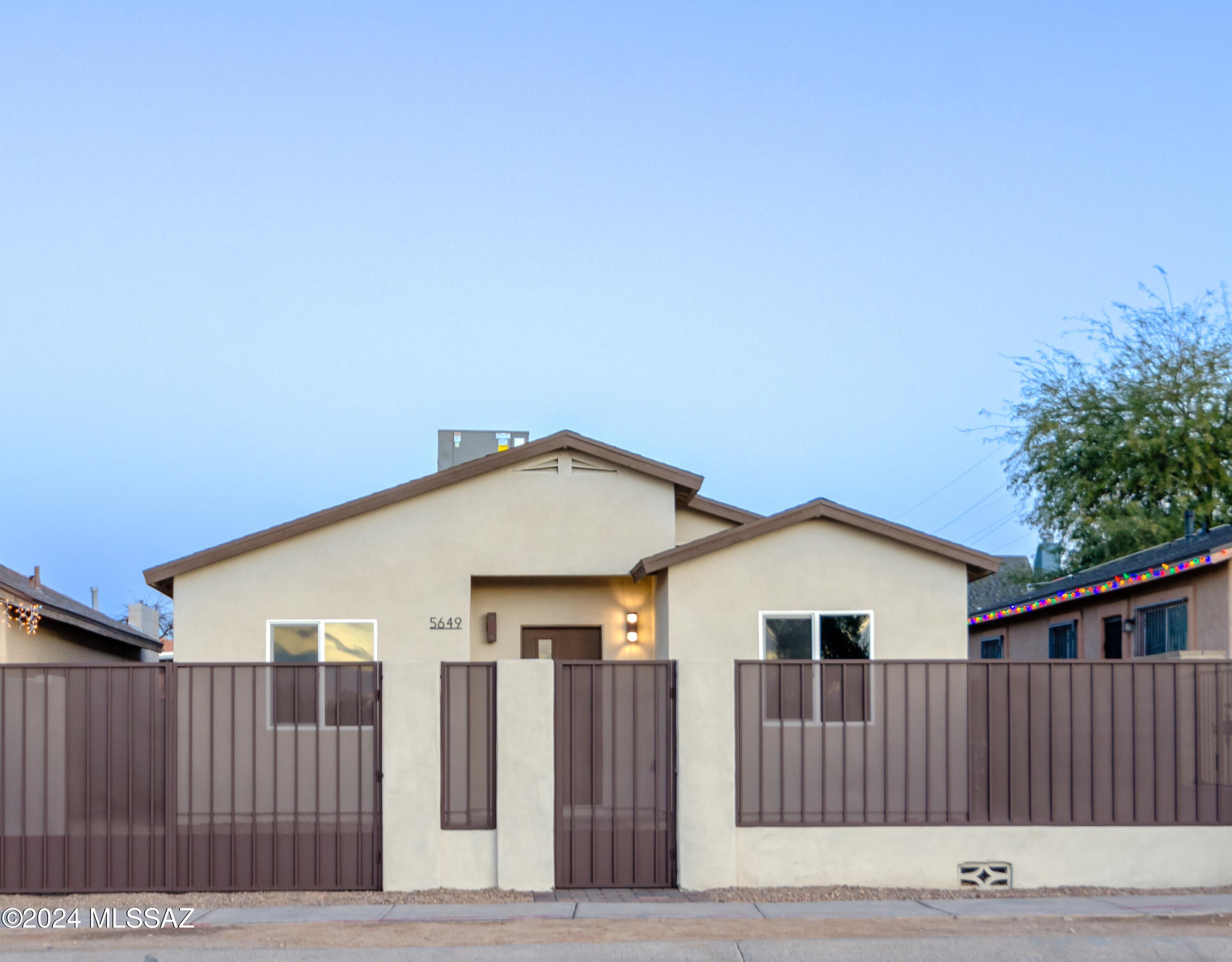 Take a look at this new construction in south Tucson. This single-family 3-bedroom 2 bath home features an open-concept layout that seamlessly integrates the living, dining, and kitchen areas, making it perfect for entertaining and family gatherings. With ample natural light flowing through, every corner feels warm and inviting. The modern kitchen is equipped with quartz countertops, stainless steel appliances, a spacious walk-in pantry and beautiful modern and sophisticated fixtures. Low maintenace back yard with back gate entrance (with parking space).  A must see!
