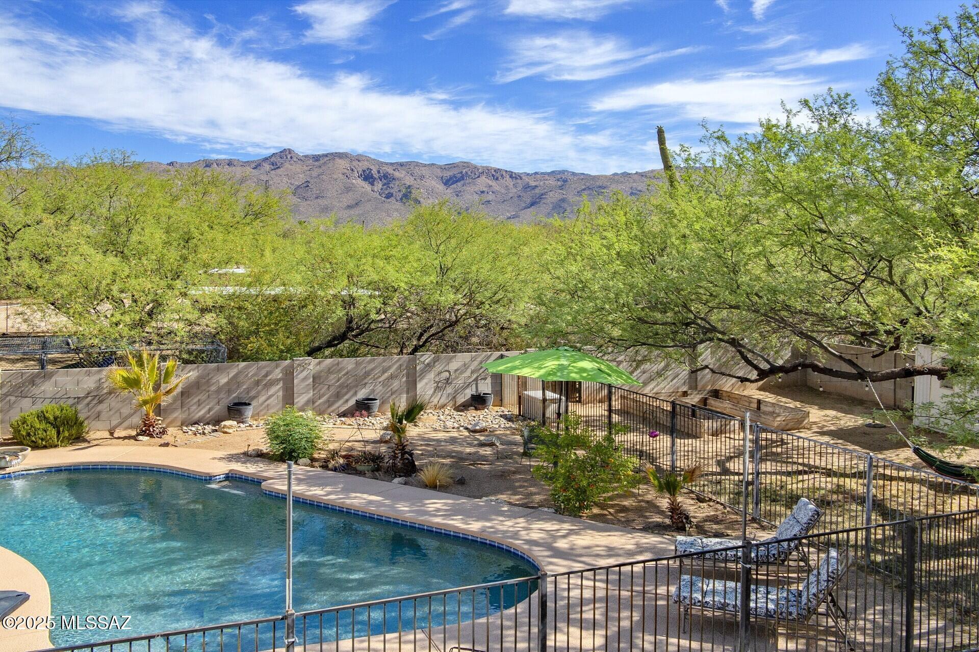 Beautiful mature Mesquite trees dot the landscape of this terrific home on a flat Acre+ lot in sought after Bel Air Ranch Estates. Perfect for those seeking a rural lifestyle. 4 Bedrooms plus a large Bonus Room that could be your 5th bedroom, playroom or artist studio. Tile flooring throughout. Large bright kitchen with garden window, breakfast bar, island, granite counters, SS appliances, double ovens, pantry, lots of storage. Family room offers a wood-burning fireplace to enjoy on a chilly evening. Enjoy the beautiful Mountain View as you cool off in the pool or relax in a hammock.  Raised beds are just waiting for you to plant some veggies and flowers. Large  3-car garage boasts space for your workshop, with 200 AMP service, tons of existing shelving, and work-sink.