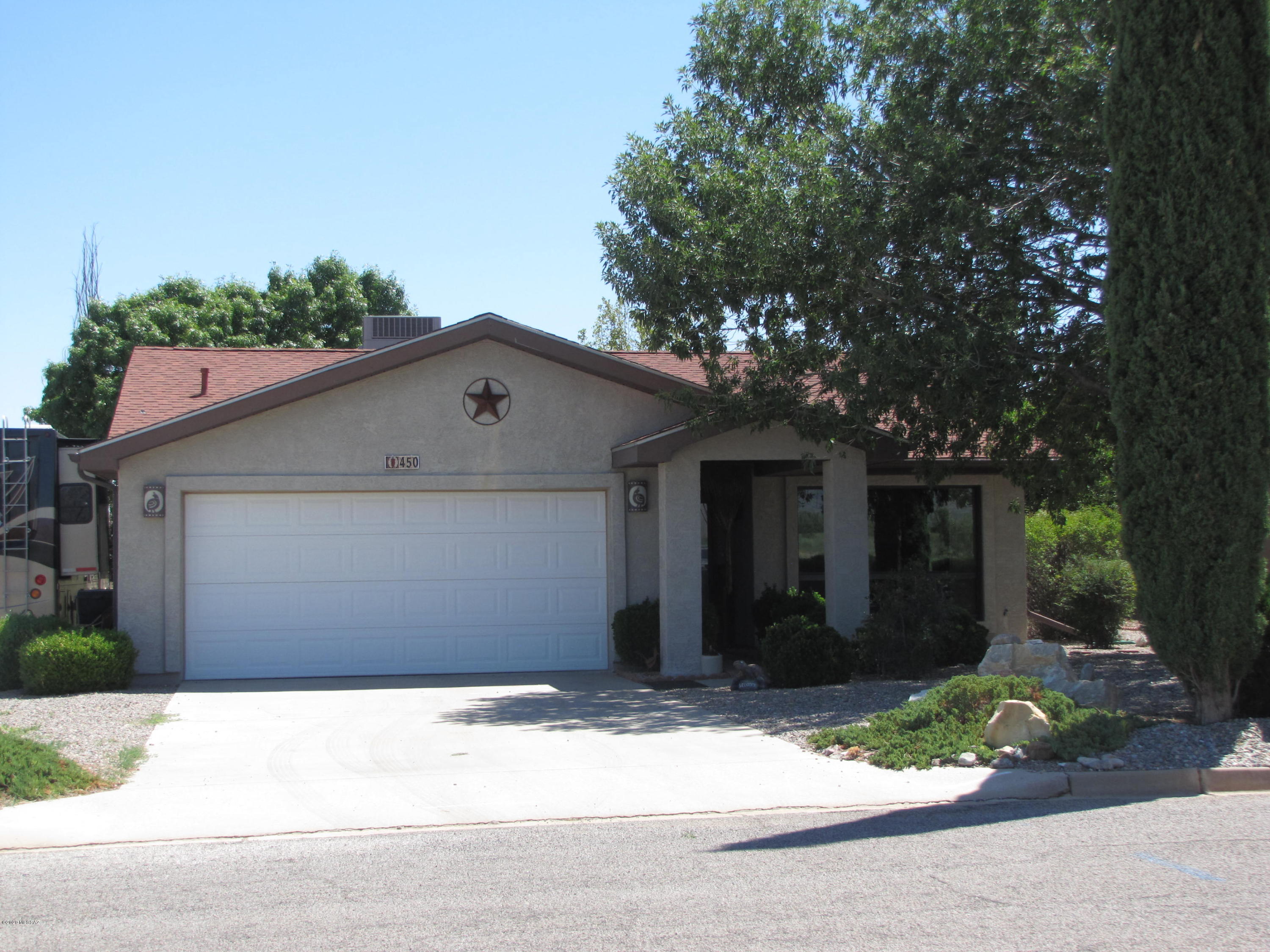 This 2BR/2Ba home with an incredible view of Cochise Stronghold is waiting for you!  Covered sidewalk/entrance to front door. LR with wood burning FP, looks out picture window toward Dragoon Mtns. New windows throughout in 2013. Open kitchen/dining area with breakfast bar and skylights. Newer appliances; new SS sink and garbage disposal.  Two sliding doors open into AZ room, leading to covered patio and backyard. Newer ceiling fans in all rooms.  Jacuzzi tub in MBa. New custom shower in guest bath in 2019. Second BR is office & BR at once with built-in desks & shelves along with a Murphy bed. Also has window seat with storage. New roof in 2010. New furnace and A/C in 2019.  Two-car attached garage with new  water softener. Detached 22x30 garage with electric. Large barn storage shed (on skids) behind garage. Electricity and water hookups for RV on side of house. Plants on automatic drip system. Not far from amenities of Sunsites. Quick and easy access to Hwy 191 and I-10
