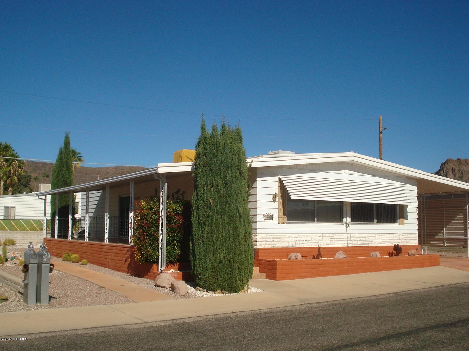 OWNER WILL CONSIDER ALL OFFERS!  This well maintained home is perfect for year around or winter snowbirds.  2 bedroom, 2 bath home.  Large kitchen with island.  Covered patio for your enjoyment.  Workshop/storage building perfect for golf cart storage.  55+ Community of Tucson Estates; $128 HOA fee includes free golf, tennis, shuffleboard, 3 pools, spa, exercise room, trash service, over 75 activity groups and clubs, ...and more! You own the land! AZ retirement at its BEST! 15-minutes to downtown Tucson and many major venues!