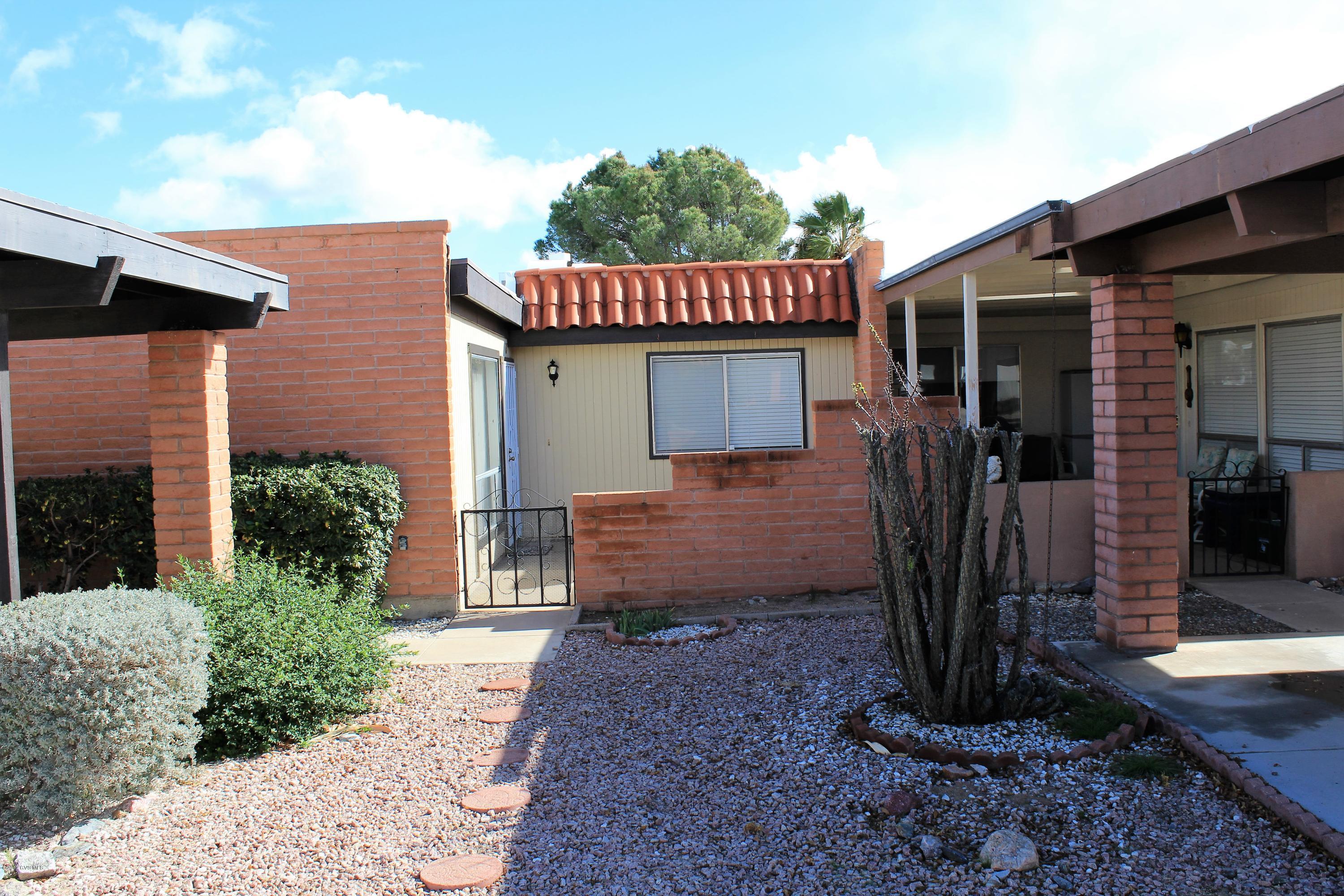 Whether you plan to live here full-time or part-time, this townhouse could be just 'the one'. The county reports the home as 902 sq. feet but there is an added Arizona room bringing your total sq. footage to almost 1,100. The biggest bonus is that the home has brand new kitchen appliances (except fridge) - installed 1/20/17 and never used. There is also a stack washer/dryer in the closet just off the kitchen. A new security door at the main entry and a new iron gate on the back patio were installed recently. The back patio offers some view of the mountains. This centrally located townhouse is close to stores, banks and churches with lots of sidewalks for long walks. Repairs from recent home inspection have been completed.