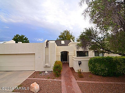 Luxury Townhome in exclusive Sam Hughes neighborhood in a small lush green community. Large Spacious Rooms. Family Room features Vaulted Ceiling and Warm & Inviting Beehive Fireplace. Kitchen with Gas Range, Built-in Microwave, Breakfast Nook Overlooking a Courtyard & Oversized Pantry/Storage. Dining Room Accommodates a Large Table for Entertaining. Double Sprawling Master Bedrooms & a Spacious 3rd Bedroom. Master Bathroom with Soaking Tub, Separate Shower & Dual Sinks. Full third Bathroom & Laundry Room. 2-Car Garage with Storage Room. New Roof. Fabulous Outdoor Living Space Featuring a Shady Covered Porch, Extended Brick Paver Patio & Mature Landscaping. Prime Location near the University of Arizona, UMC & Rincon Market!