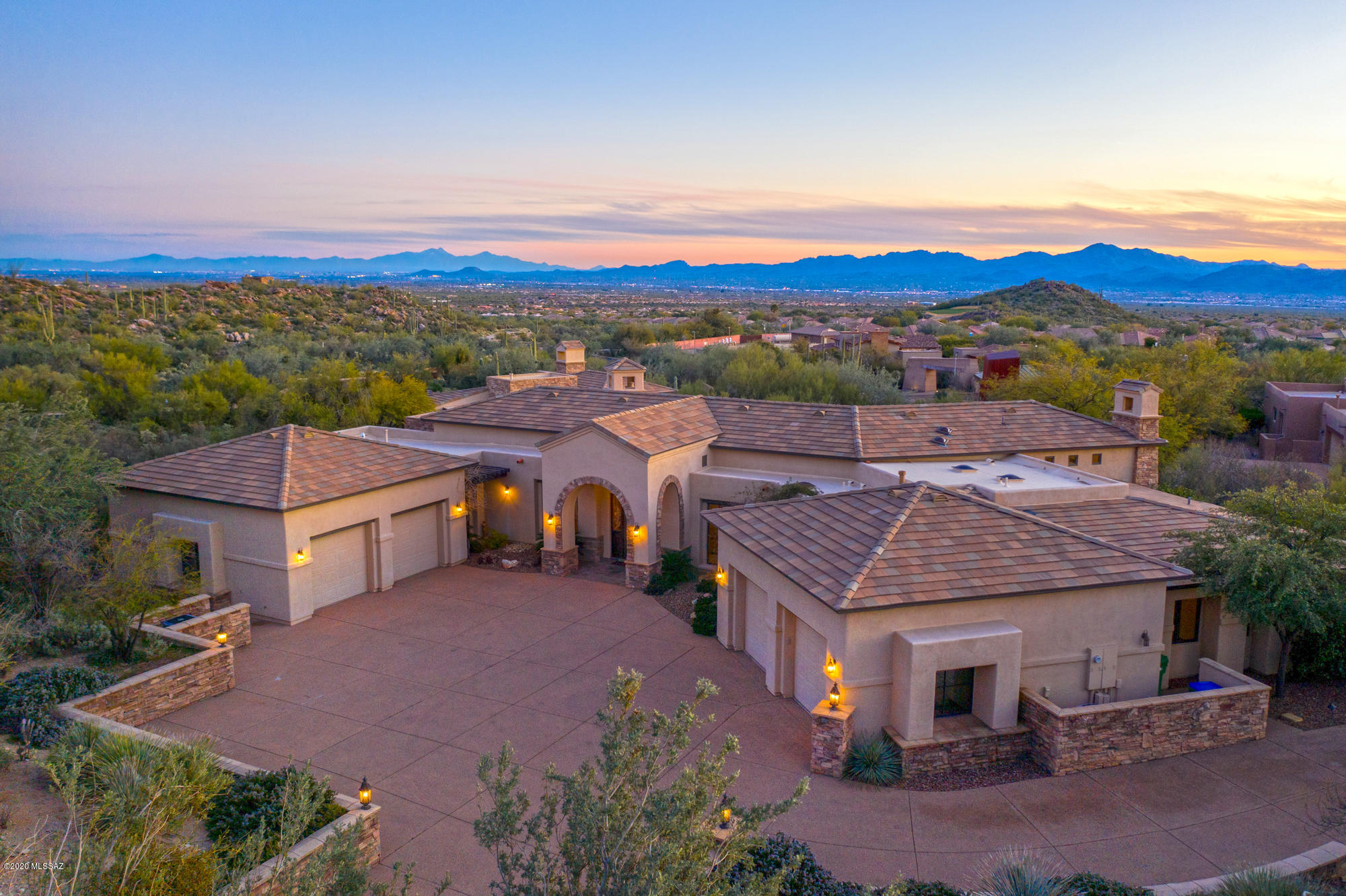 Welcome to Dove Nest!  Estate Living in Guard Gated Canyon Pass @ Dove Mountain! This gorgeous home has ample square footage for the entire family and guests alike with a floor plan that feels easy and flows well for entertaining.  The main house provides 4,634 s/f, 5 bedrooms and 3.5 baths.  The separate, detached guest house allows for another 2 bedrooms, bath and living room with fireplace and small kitchenette.  In the main house, the grand entrance welcomes your guests to an elevated view of the formal spaces of living and dining and then out into the expansive outdoor space.  The kitchen is pure gourmet with top of the line appliances, large island with prep-sink, warming drawer, generous counter space, cabinetry and walk in pantry.  You'll stay close to family as they spend time in the warmth of the family room and breakfast area.  Split bedroom layout with 3 guest bedrooms on one end with one as an ensuite and the other features a Jack and Jill design.  On the other end next to the master you'll find an additional space that can be used as den/office/exercise or 7th bedroom.  The master suite is a true retreat with large bath, dual separate vanities and closets, walk in shower and jacuzzi tub.  The separate guest house is a dream for multi-family living or guests galore with living space, kitchenette, fireplace, two bedrooms and bath.  You'll spend plenty of time in the backyard with large covered patio, fireplace, putting green, pool and spa and expansive patio space.  The area is a golfer's playground as this property is surrounded by some of the finest golf courses in the area!