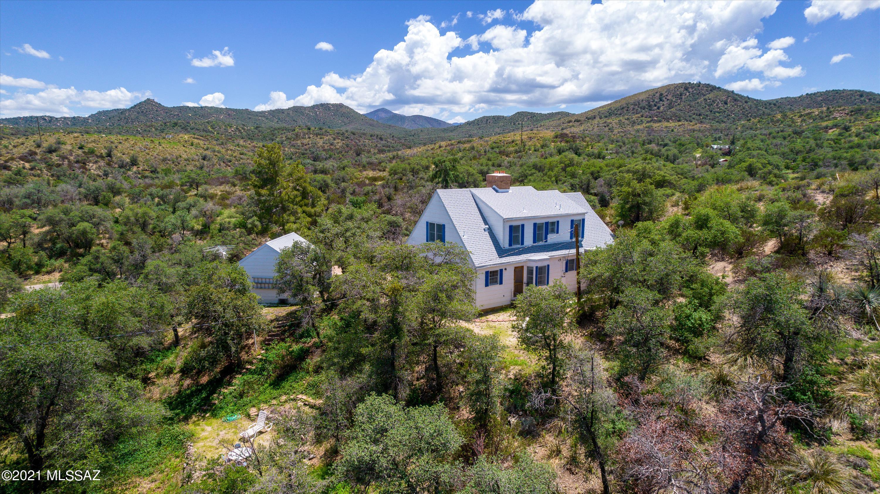 Location, Location, Location! Character, charm, privacy, & mountain views just to mention a few of the fantastic reasons you'll love this home! Located in the beautiful town of Oracle, this 3 bedroom, 2 bath home sits on 1.27 acres. Covered in oak and pine trees, & comes with 2 garages which includes a workshop area. A brand new roof was just installed for you to enjoy for many years to come! Wait until you experience the adorable front porch where you can enjoy your morning coffee with the birds. This 2 story home has a bedroom on the main level & check out the original hard wood floors and 2 wood burning fireplaces! Room to add your own special touches! Start enjoying small town living today with cooler temps & hundreds of miles of hiking trails right at your door step.