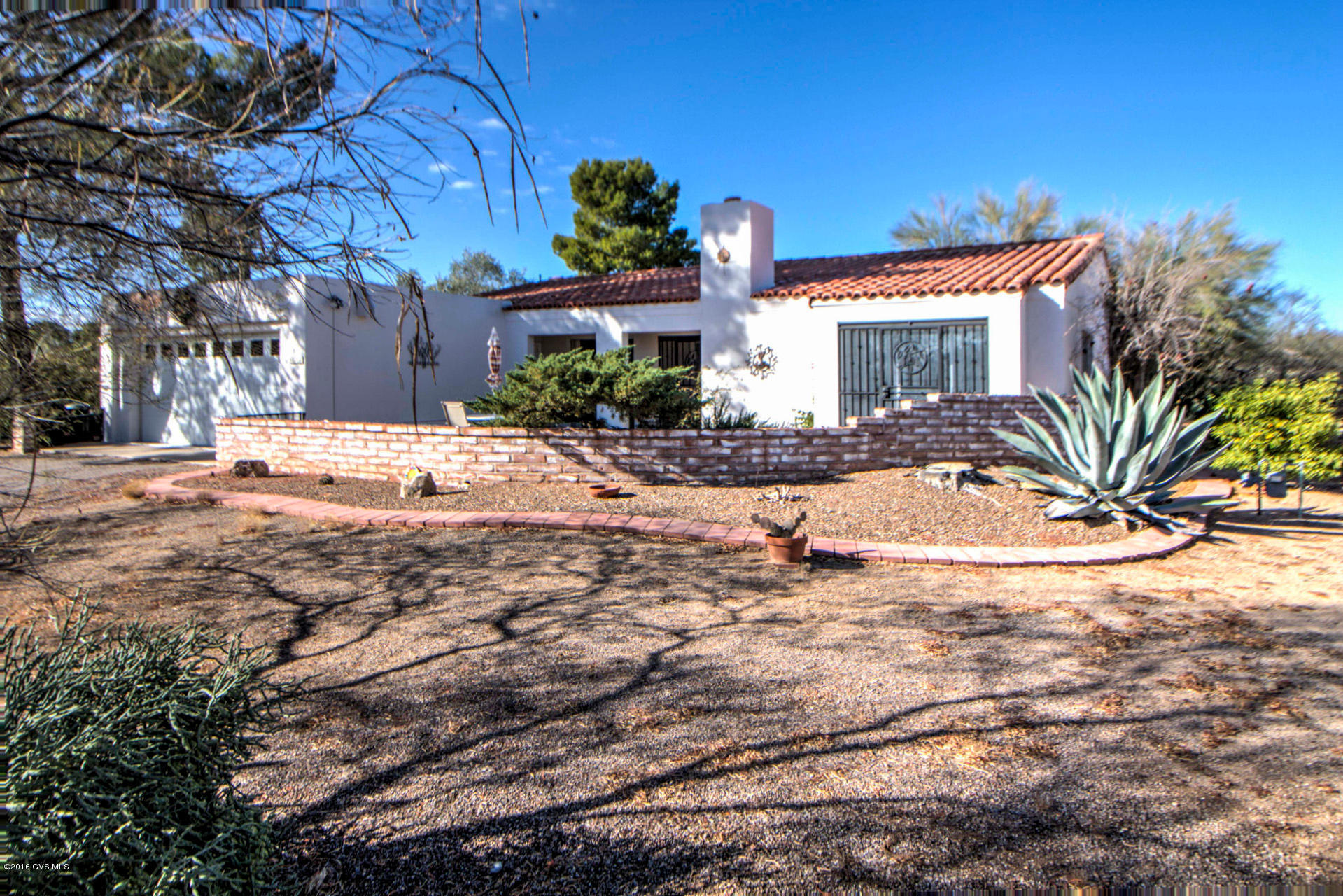 Desirable natural desert setting in the center of Green Valley. Large living room, Arizona room, laundry/utility room, dining room, 3 patios, adobe brick wall, 2 car garage and carport. Citrus trees on the north side of home. Turn left onto La Pintura, 2nd driveway on left to get to front door.