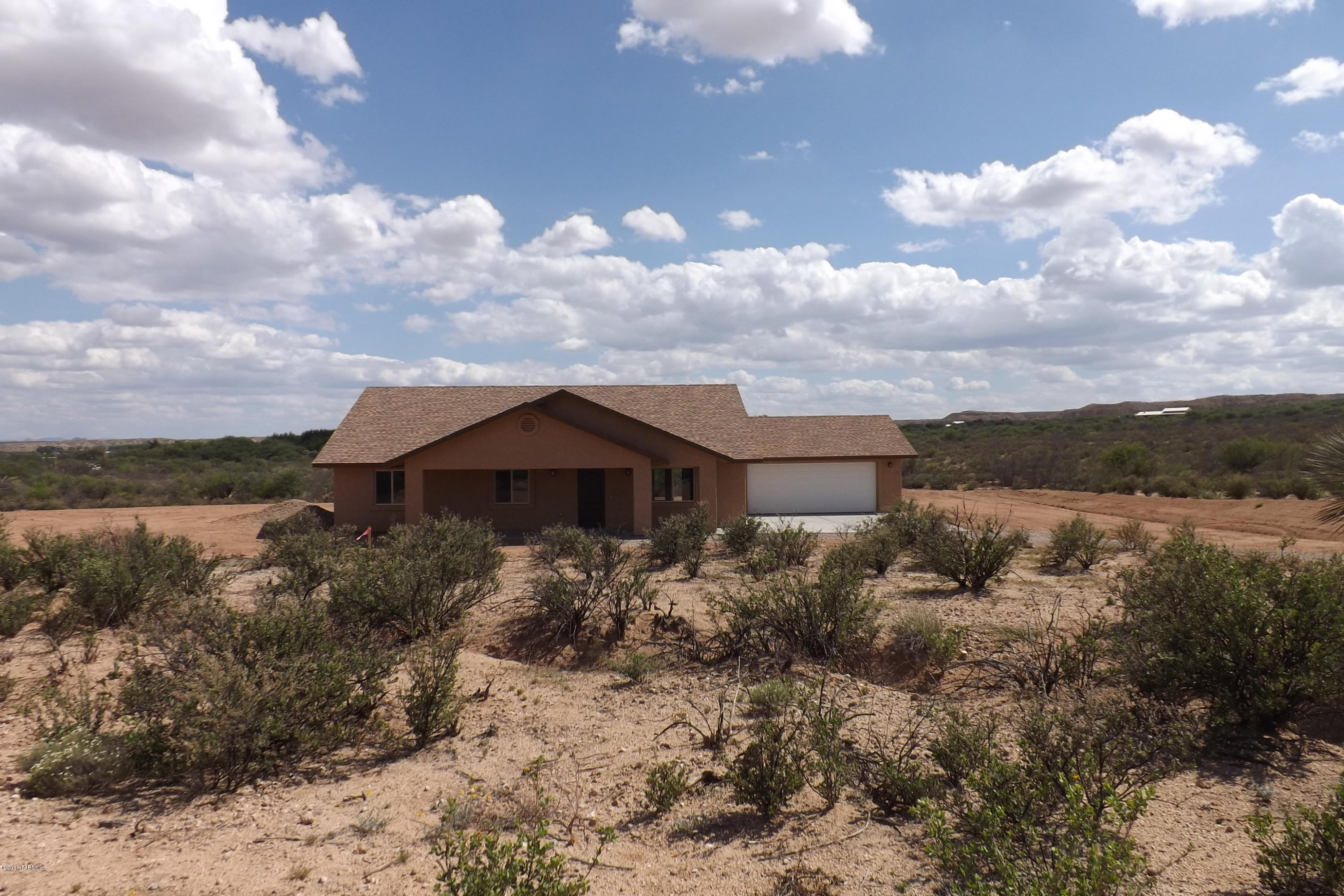 Price Reduction!Why buy used when you can buy this newly Constructed home on 4 Acres located just minutes from Benson Arizona. Ranch Style home with tall vaulted ceilings, Fantastic stained concrete floors, Kitchen with upgraded maple cabinetry with soft close doors,  oil rubbed bronze fixtures, stainless steel appliances and matching granite counter tops in kitchen and baths. Light and bright20x18 Master suite with walk in closet and bath with dual sinks.  
Energy efficient, 2x6 construction with spray foam insulation. Deep porches on north and south side of the home to enjoy perfect Arizona weather. The 4 Acre parcel has plenty of space to add a workshop or horse facilities. Large 576 Square foot 2 Car Garage with exterior door that lead to back porch. Additional acreage is available.