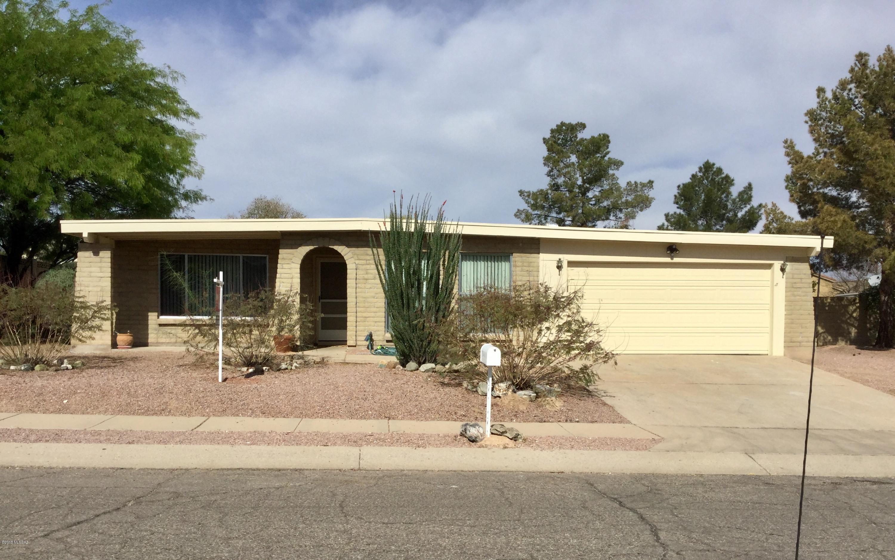 Quality slump block construction and great east side location! Spacious floorplan with formal and casual living spaces, fitted with tile floors throughout (no carpet), updated kitchen, den with fireplace and split bedroom floorplan. Nice natural light with good size windows in every room.  Kitchen has granite countertops, stainless sink, flat top stove and an pantry room for extra storage or prep area plus freezer space if needed.  Breakfast bar seating plus ample formal and casual dining areas. Large E/W yard has big covered patio with mountain views to the North, 2 producing citrus trees, oversize garage, new water heater, roof just serviced/coated, fresh exterior paint, plus huge detached workshop with electricity and cooler and double gate access in backyard. This is a must see home!