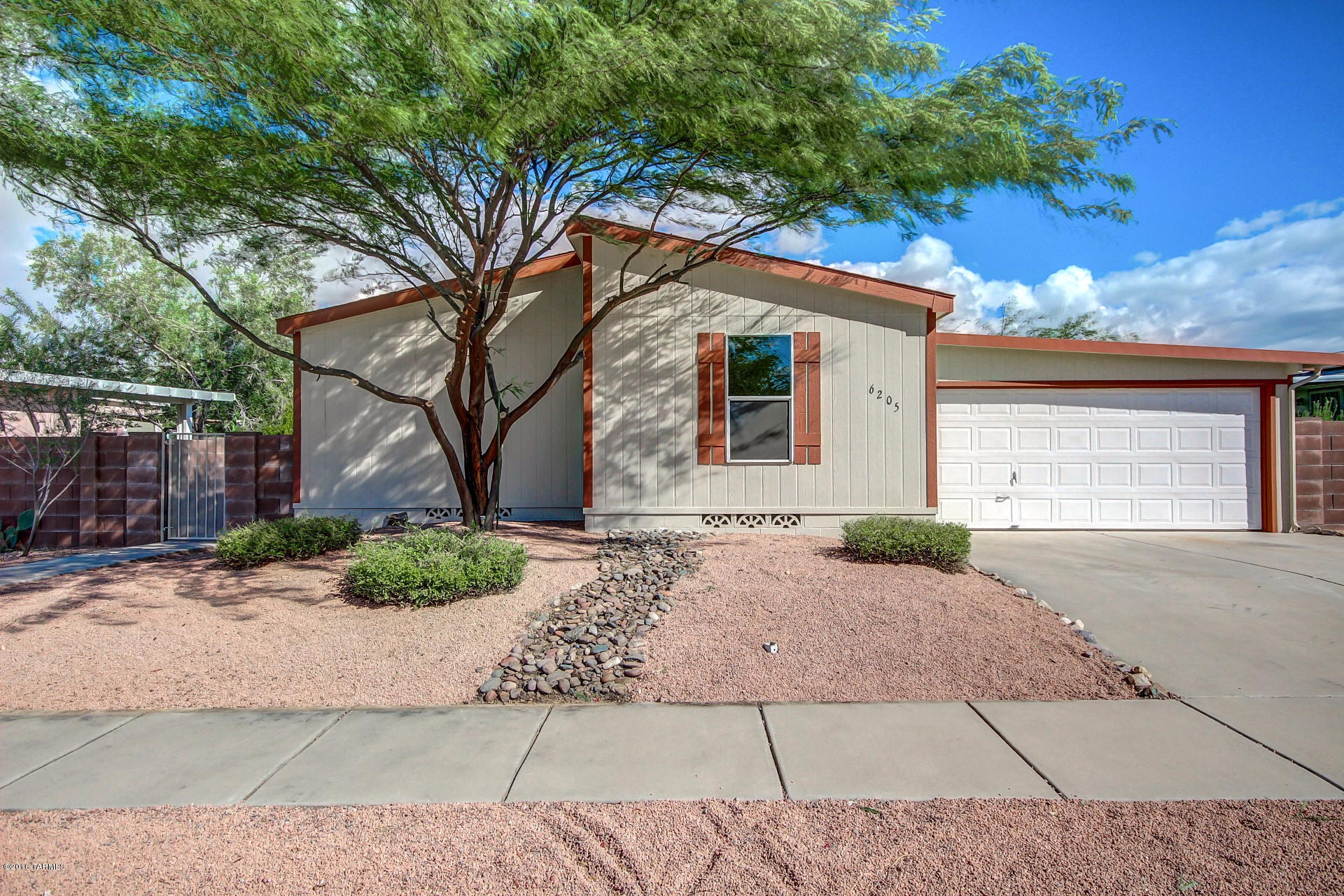 Newly renovated home with vaulted ceilings and a neutral color palette throughout. Enjoy vaulted ceilings, wood flooring in the main areas and fresh two tone paint throughout. Upgraded kitchen features stainless steel appliances, custom cabinetry, center island w/breakfast bar and ample counter space. Each spacious bedroom has plush carpeting. Master includes an adjoining bath. Both baths have tile surround showers with decorative accents. Easy care landscape with mature trees and a storage shed in back! Make this home your first and last stop! See it today and start packing! Owner is a licensed real estate agent in the state of AZ.