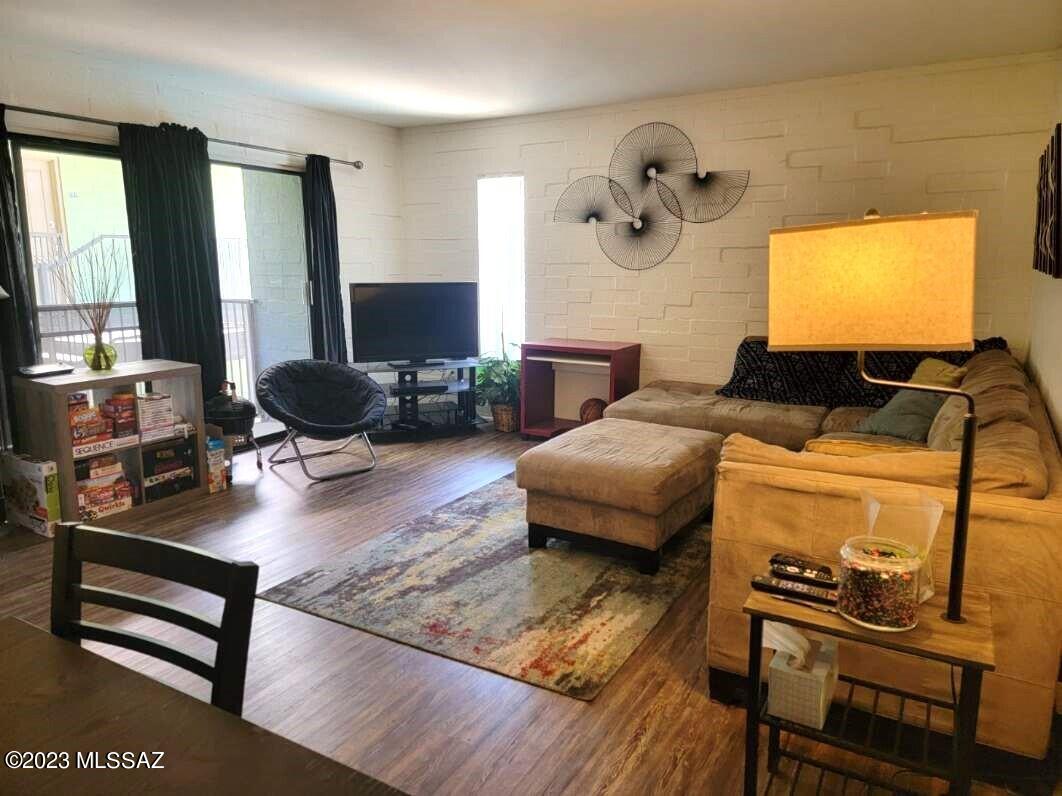 Don't miss out...these condos sell fast! Walk to classes at the UA! Owner updated this gorgeous condo with laminate flooring in living area & plush carpeting in bedroom, awesome furniture (still under warranty), and so much more. All you need is your personal belongings. Spacious 10'x15'3'' bedrooms with large closets. Kitchen has granite counter tops, stainless steel appliances (refrigerator, black top stove, microwave & dishwasher) and ceramic tile flooring. Up-graded tile back-splash in kitchen and bathroom. Main bathroom ideally set up for roommates with two cupboards, two sinks, two stacks of four drawers, two medicine cabinets and granite countertop. Up-graded tile surround in bathtubs/shower with built in shampoo niche. Desirable corner unit located in the middle of the complex. Close to study lounge, laundry facilities, parking space and swimming pool. Campus Walk is around the corner to the main gate of the UA and Main Gate Square featuring numerous restaurants, shops and the trolley to 4th Avenue and downtown.