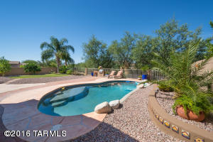 HERE IT IS-IN ONE OF ORO VALLEY'S MOST DESIRABLE NEIGHBORHOODS! Walking Distance to Schools, Shopping Centers and Public Transit. This highly maintained home features: A Split Floor Plan, Security Screen Doors at EVERY Entrance, Plantation Shutters throughout,Maintained Roof Jan 2016,New Pool Motor 2016, Tile & Laminate Wood Flooring-NO CARPET! The Open Gourmet Kitchen boasts of Granite Counter Tops, A Walk-In Pantry with Plenty Of Storage and Stainless Steel Appliances. Enjoy the spacious SERENE back-yard that offers plenty of PRIVACY, Mature Fruit Trees & A Sparkling Pebble-Tec Swimming Pool. This is a MUST SEE home with all the extras!!