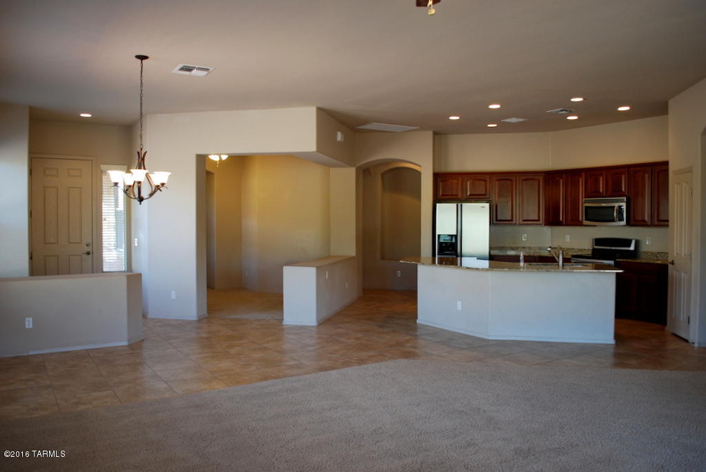 Open and Spacious 3 Bed 2 Bath w/Den in Gated Preserve at Dove Mountain. Huge north facing lot with low maintenance yard. 1964 sq ft, Whole house has 10 foot ceilings. Gourmet kitchen with Cherry cabinets, SS appliances & Granite Counters. Large kitchen island with wrap around breakfast bar. Master suite has private access to patio and large walk in closet. Master bath has separate tub & shower and dual sink vanity. All rooms have ceiling fans. Mud room has sink and full size washer/dryer. Tandem 3 car garage. This home is offered as NON-SMOKING. Pets subject to owner approval.