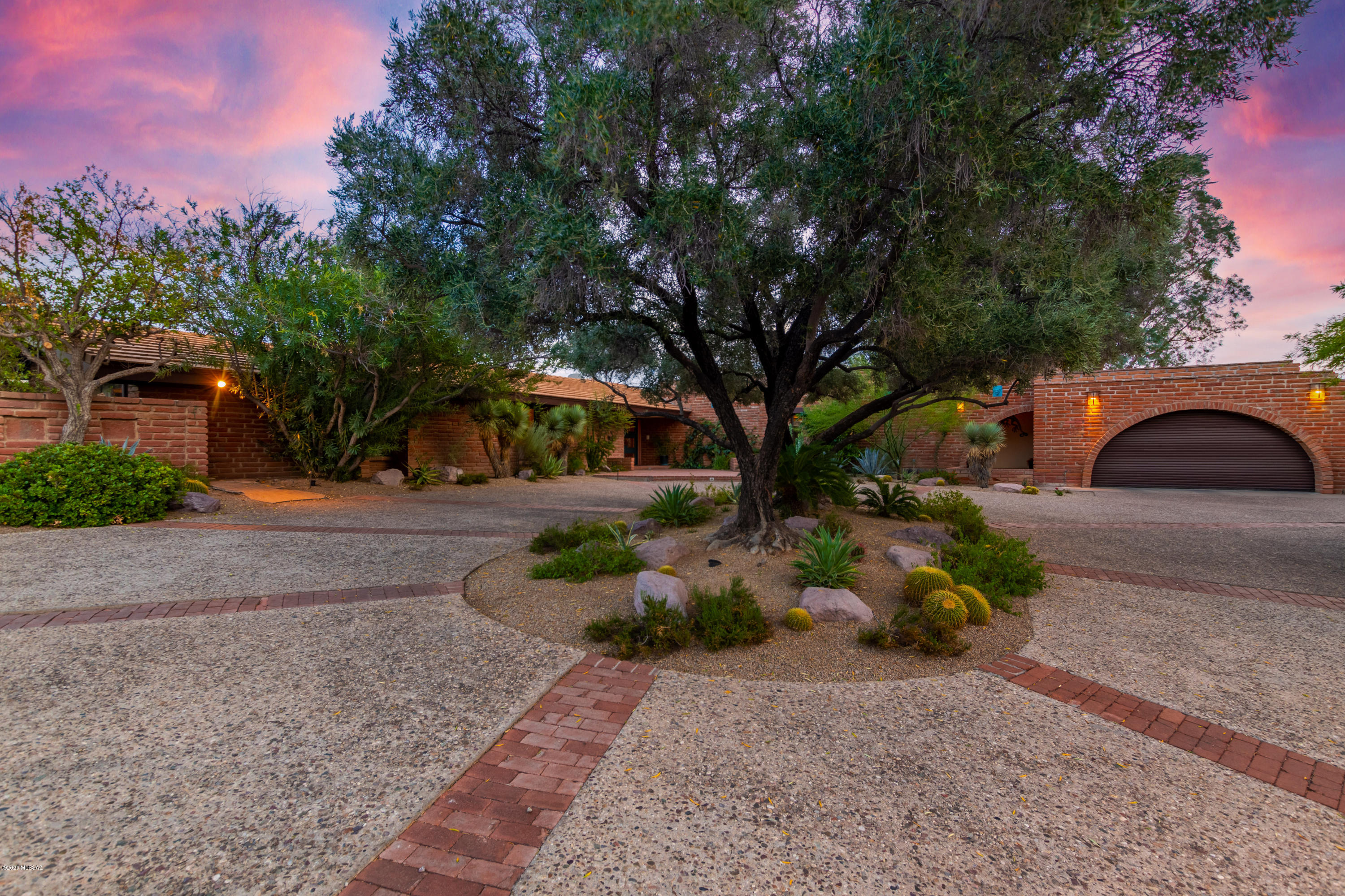 One of a kind, architecturally designed home. This expansive 6 bedroom, 6 bathroom home offers 5,813 Sq Ft of unique features and gorgeous architecture. Built in 1958 and designed by Nicholas Sakellar. Enter into the teak floor foyer that opens up into the massive great room with support beams delivered from Oregon, hidden motorized bar and two sliding glass doors to bring the outside in. Full length glass pocket door in the formal dining area that leads out on to the back patio with stunning city views. Kitchen has been updated with bamboo floors and custom cherry cabinets by Tom Klijian. 2 car garage off kitchen with access to an air conditioned workshop with additional washer and dryer hookups. 2 beautiful sunrooms with horizontal solar screened windows, one of which has Occupied Japan tiles from 1945. The second sunroom/office, master bedroom and bathroom were added onto the home keeping the integrity of the original design. The master bathroom was updated in 2011. It is equipped with a giant tub, shower, dual vanity and heated floors for extra comfort. The lower level of this home includes a laundry room, bathroom, two guest bedrooms, and a breeze way leading to a second 2 car garage.  This home has incredible mountain and city views with lots of land and privacy.