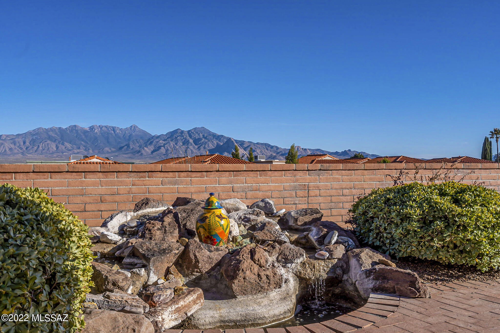 Spectacular, panoramic view of the Santa Rita Mountains and Santa Cruz River Valley stretching from Tucson to Nogales as well as the Rincon Mountains in Northeast Tucson. Enjoy these views from the comfort of your kitchen/breakfast nook and great room or from the privacy of your rear patio. Saltillo tile compliments the freshly painted desert tone walls. Both bedroom suites have new carpet. The split floorplan assures a completely private en suite guest bedroom. The office can be closed for security and tucked out-of-sight. Within the 2.5 car garage you will find abundant storage cabinets, a built-in workbench, utility sink, new water softener, hot water heater with recirculating pump and HVAC system installed in 2015. The secluded side yard contains citrus trees, access to the garage and an elevated sitting area for captivating mountain views.