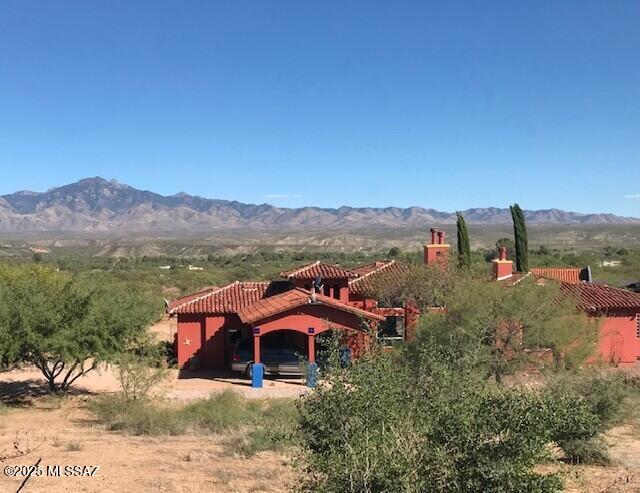 Nestled in a quiet, gated, non-HOA community sits a custom-built home on 3.77 acres boasting exceptional architectural details and modern amenities. The property is surrounded by majestic mountain ranges and desertscapes.
The main house consists of rooms that are thoughtfully designed to maximize comfort and functionality.  It includes two large bedroom suites, each with separate shower and jetted tub.  The main bedroom has a fireplace and sliding doors which lead to the private patio and fountain.  Its bathroom includes dual sinks, a vanity, roman shower and walk-in closet. The large open living room has a kiva fireplace, beamed ceiling and windows looking out to the pool and mountains. The kitchen features a large mesquite center island and newly refurbished mesquite countertops, accented with decorative tile work, walk-in pantry, and laundry room.  There are gorgeous travertine tile floors throughout the house. This house is being sold unfurnished, but furnishings may be purchased on a separate bill of sale. 
A charming stand-alone one-bedroom guest house just a short distance from the main house, is move-in-ready and offered furnished.  It has a fully equipped kitchen, living and dining room area, fireplace, ceiling fans, dual sinks in the bathroom, shower and spa tub, as well as a washer and dryer. The large wraparound patio creates cozy seating areas to enjoy mountain views.  This quaint casita can be a wonderful, private retreat for family members and guests or a potential rental income property.
A resort style patio includes a 21-foot horseshoe shaped bar with sink, griddle, a grill, a palapa with misting system, retractable TV and a large state-of-the-art saltwater pool with water features, and spa.  All of which will turn an ordinary day into a staycation. Evenings are magical.  You can enjoy the LED lighting display within the pool while listening to your favorite tunes drifting out from speakers located strategically within the patio.
In addition, there is a 40-foot motor home carport with electric and sewer hook-ups,  a 16 x12-foot shed, a workshop and a 3-car garage.
This property is truly one-of-a-kind from its bright, sunny mornings to its stunning evening sunsets. Come and experience this Desert Gem!